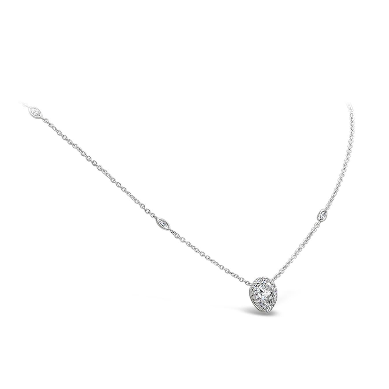 Features a 1.02 carats GIA certified as F color and SI2 in clarity, pear shape diamond set in a brilliant diamond halo. The pendant is suspended on a chic 16 inch diamonds by the yard chain. Accent diamonds weigh  0.52 carats total. Made in 18K