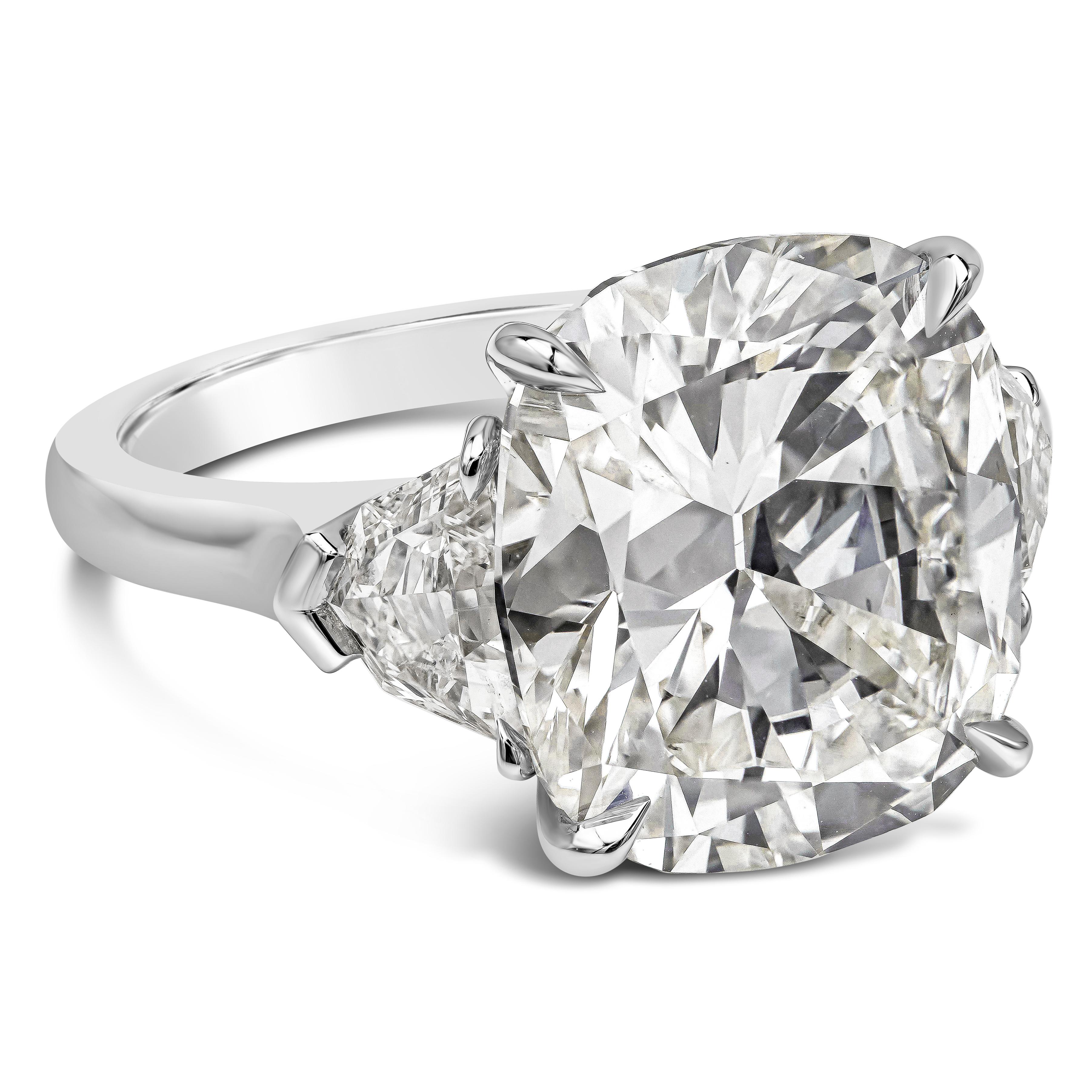 A beautiful engagement ring, featuring a 10.26 carat cushion cut diamond certified by GIA as J color and VS2 clarity. Flanked by epaulette diamonds on each side weighing 1.36 carats total with I color and VS clarity. Set on platinum. Size 6 US,