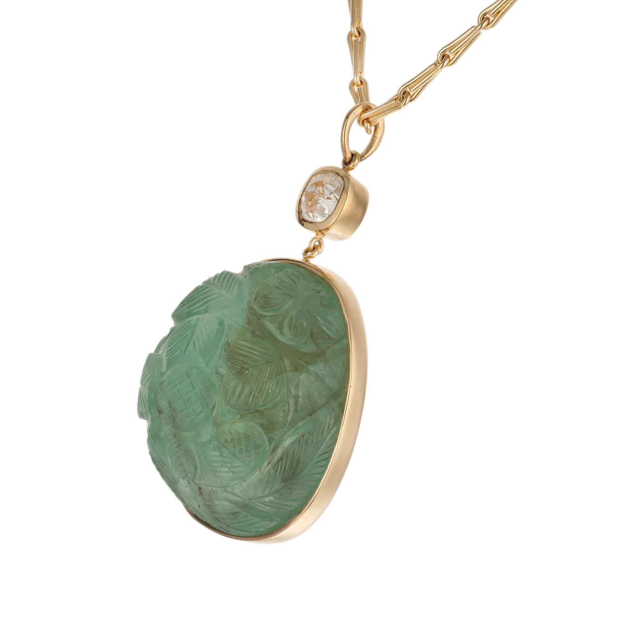 Carved mogul cabochon natural emerald and diamond pendant necklace. GIA certified natural carved green emerald with one 1.30ct old mine cut accent bezel set diamond in 18k yellow gold.  Moderately clarity enhanced. 24 inch chain. 

1 carved green
