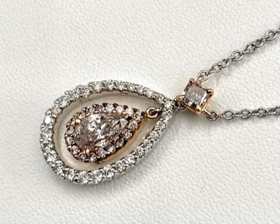 The color pink in diamonds, as a natural occurrence, is among the most rare and sought after. The pink color in this diamond is similar to a subtle blush and has an even distribution of hue. The diamond is surrounded by  a halo of natural pink
