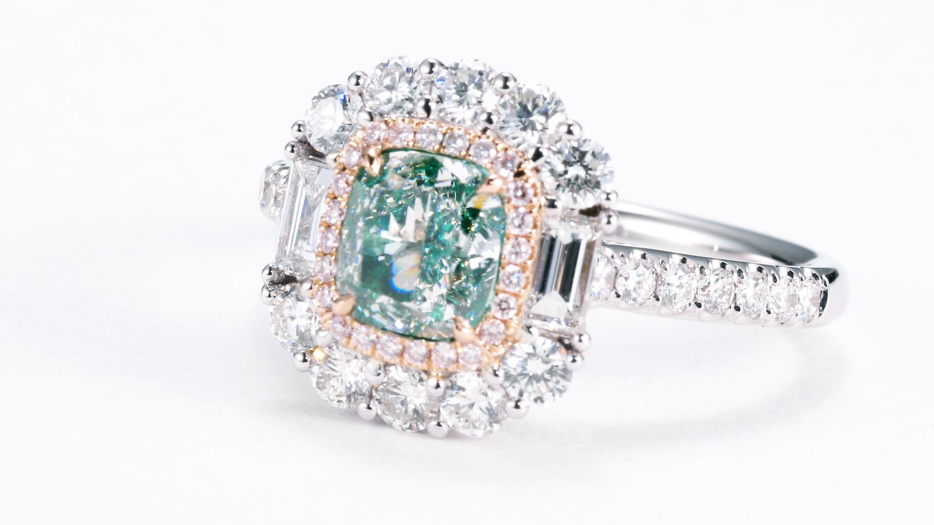 a breathtaking jewelry piece featuring a 1.02ct VS2 GIA certified natural fancy color, very light green-yellow cushion-shaped diamond. This remarkable gem is beautifully showcased on an 18kt gold setting, adorned with a captivating arrangement of