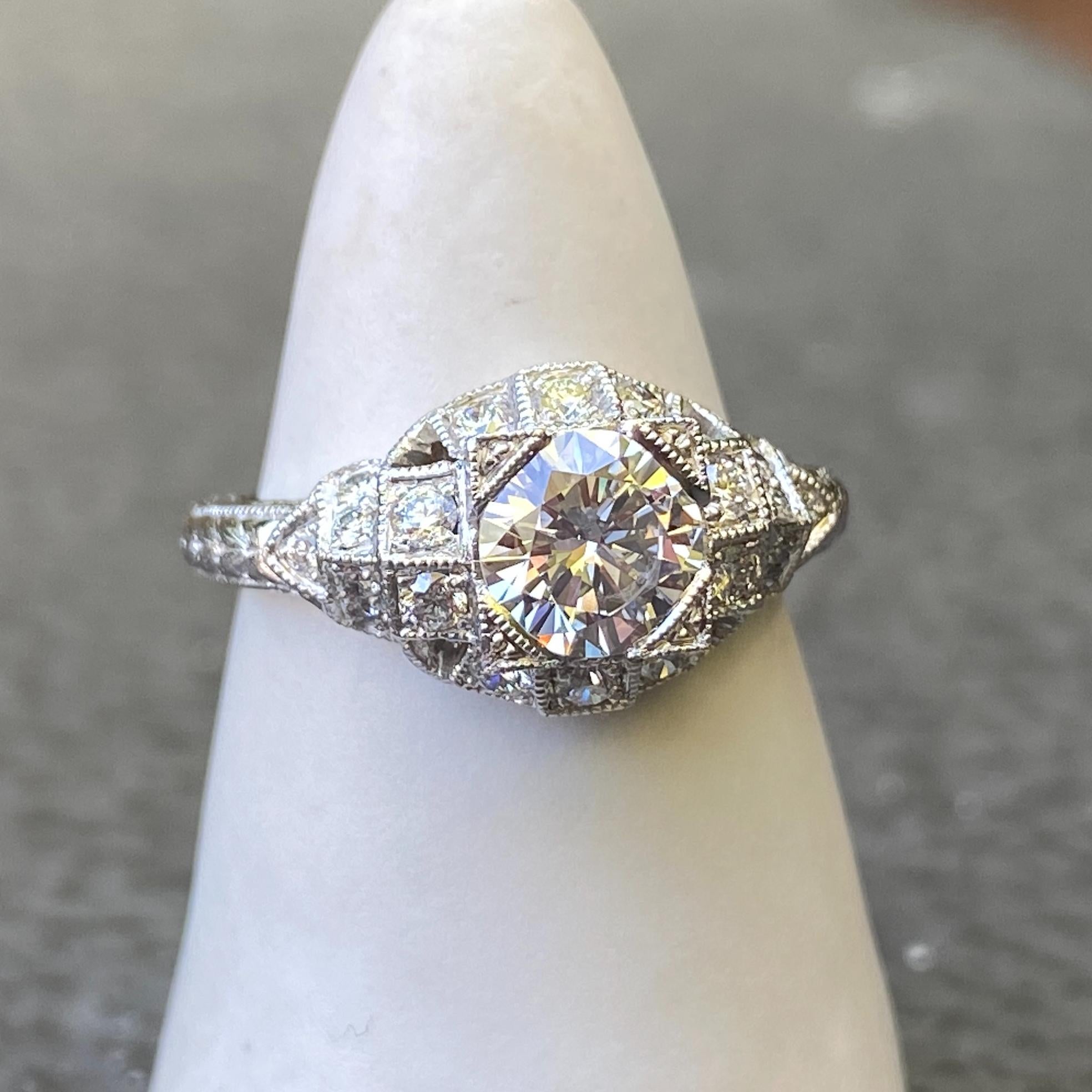 Eytan Brandes designed this ring using various elements he likes from Edwardian engagement rings, such as the carinated shank, the coin-edged pavé setting plates, and the elevated, almost bombé face.  This is the second time he has used this