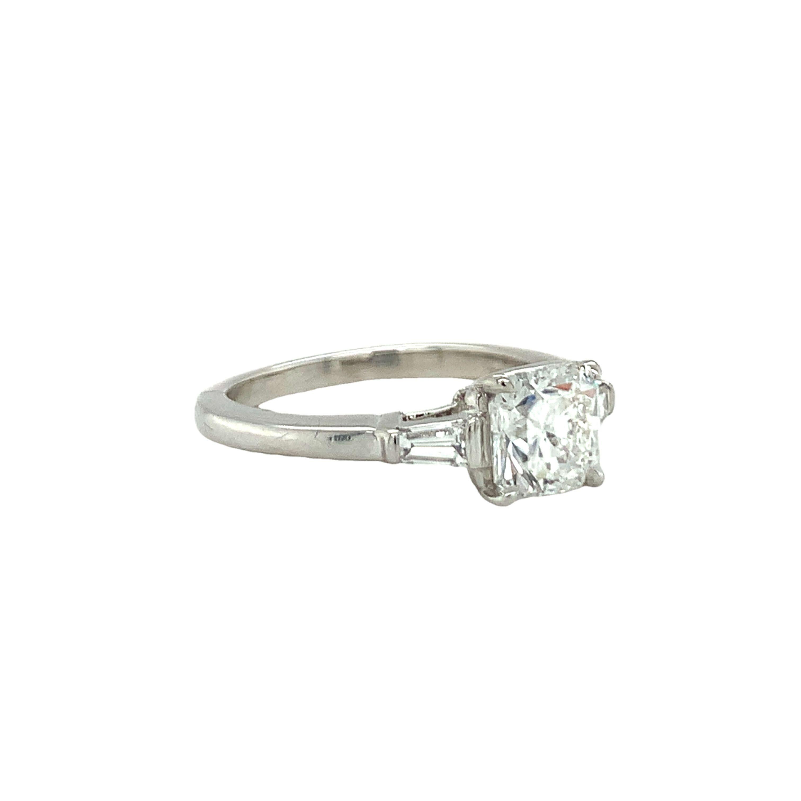 One GIA certified 1.03 ct. Lucida cut diamond platinum engagement ring by Tiffany & Co. with F color and VVS-1 clarity and inscribed Lucida (cut cornered square mixed cut diamond). With two tapered baguette cut diamonds totaling 0.20 ct. with F