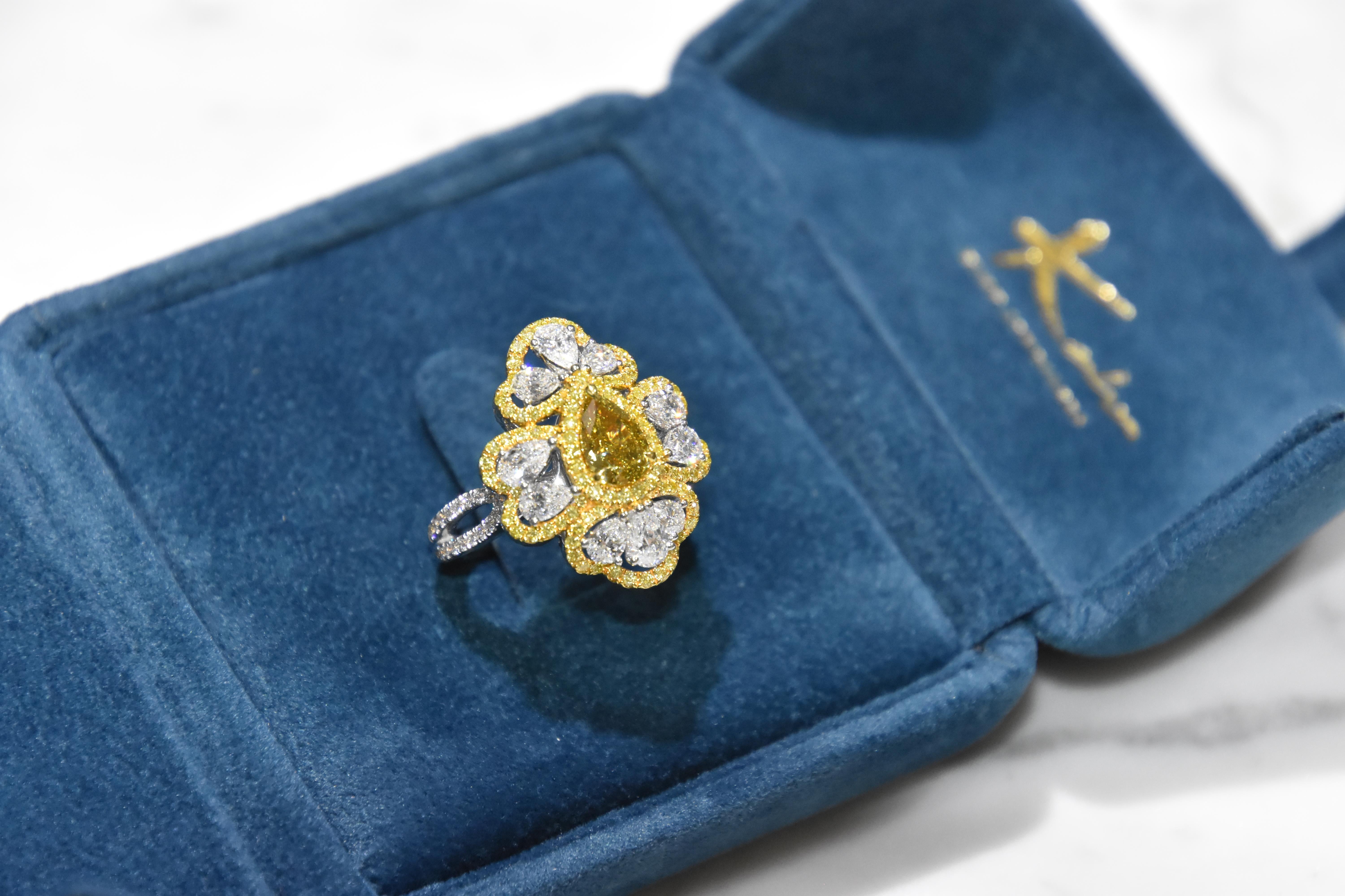 Featuring a 1.03 carat pear shape Fancy yellow diamond with white pear shape diamond finished in white gold. 
Center stone certified by world wide known GIA institution. (1179264159)

Ring size- US 6.5,   Kahn also provide engraving, resizing and