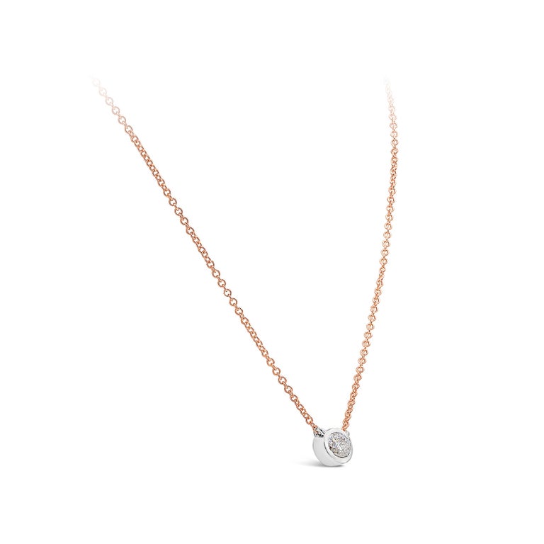 A simple pendant necklace showcasing a 1.03 carat oval cut diamond, set in a 14k white gold bezel. The bezel is suspended on a 16 inch rose gold chain. Accompanied with a GIA report certifying the diamond as I color, I2 clarity. 

Style available in