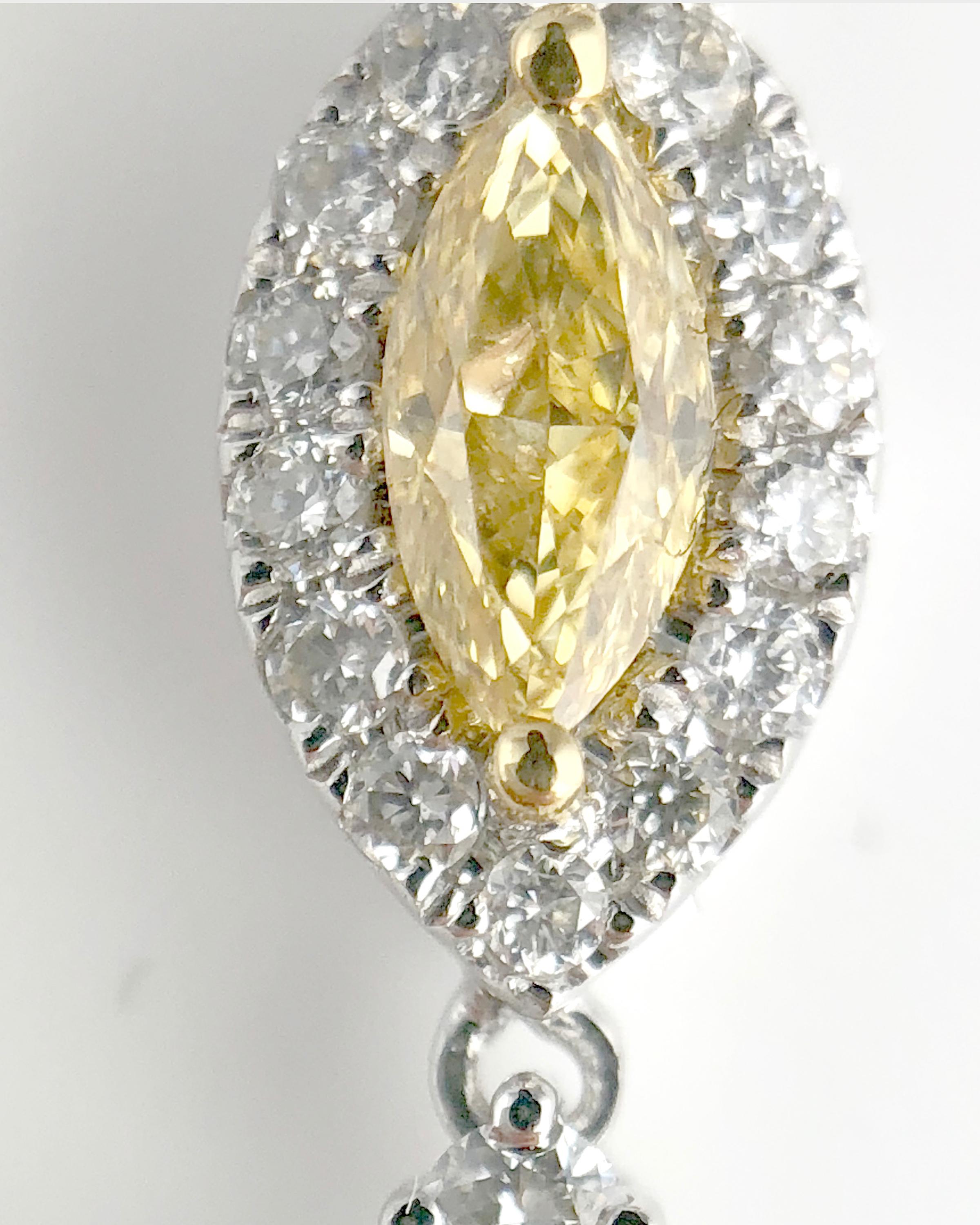 (DiamondTown) This beautiful pendant features three GIA-certified marquise cut natural color stones, each wrapped in halos of round white diamonds. The pendant is set in 18k White, Yellow, and Rose gold.

GIA Certified 0.10 Carat Fancy Intense