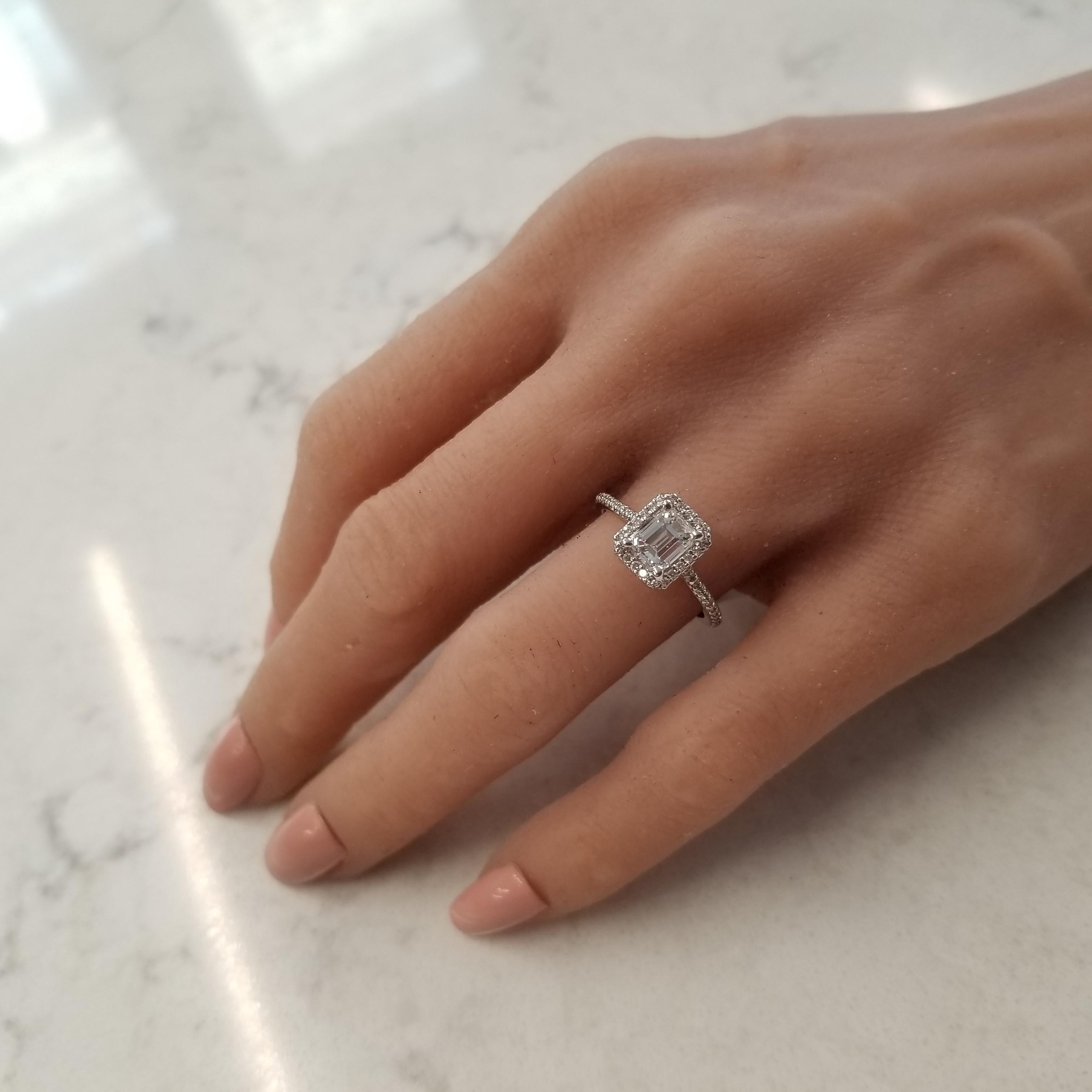 This stunning halo engagement ring is the one you seek. 1.04 carat emerald cut diamond with E color and VS1 clarity in a gorgeous classic prong setting is the center.  A total of 57 round brilliant cut diamonds adorn this center stone in a halo