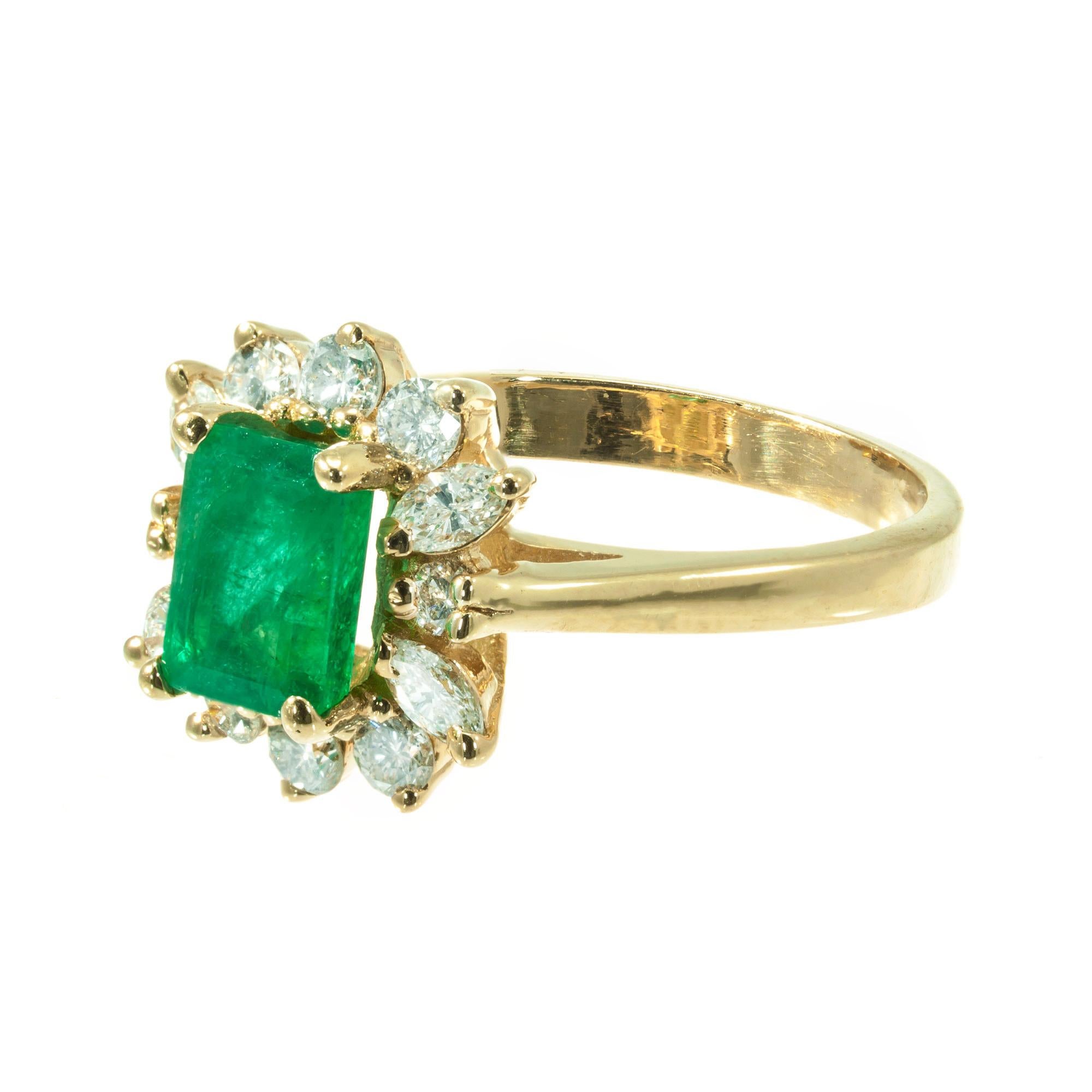 GIA certified emerald and diamond engagement ring. GIA certified, natural color, minor clarity enhancement only. Surrounded by a bright sparkly halo of round and marquise diamonds in a 14k yellow gold setting. 

1 octagonal green I emerald Approx.