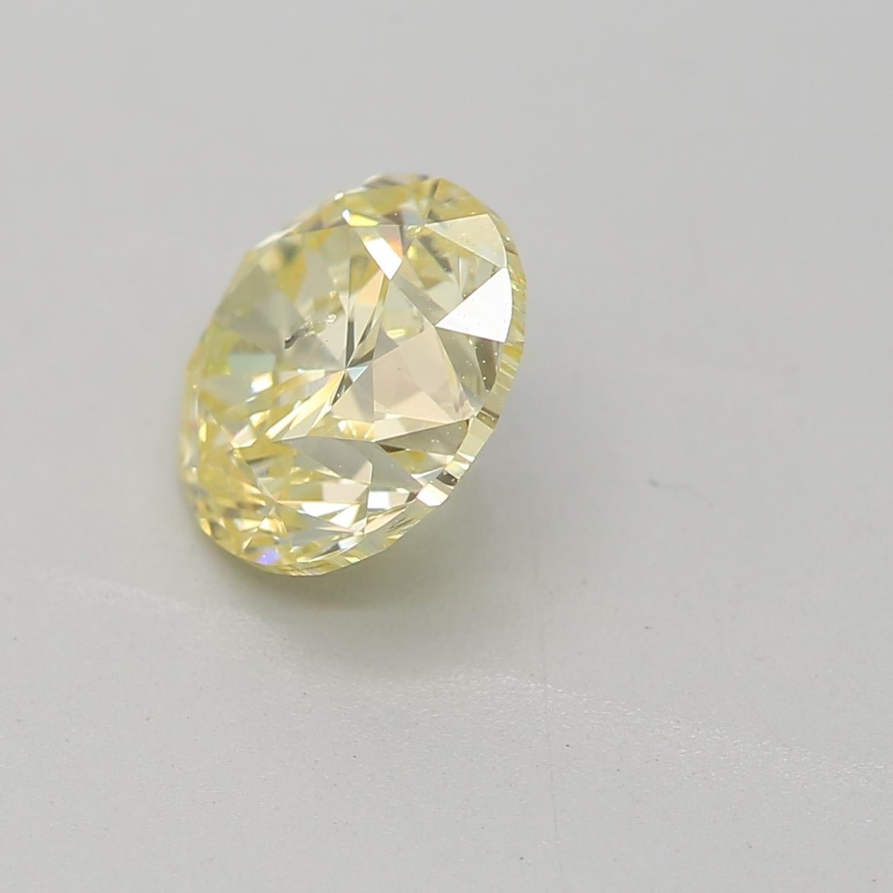 Round Cut GIA Certified 1.04 Carat Fancy Light Yellow I2 Clarity Diamond For Sale