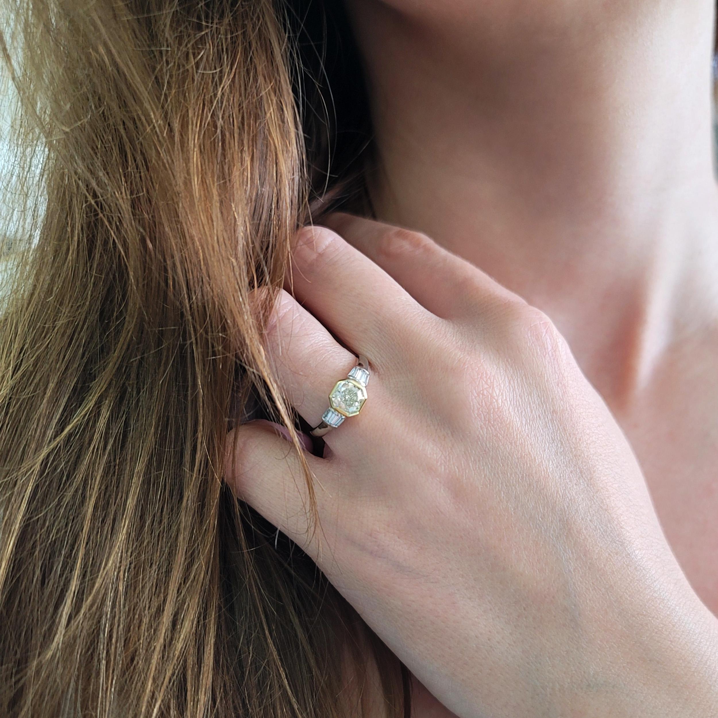 GIA certified  1.04ct color diamond and 0.20ct white diamond ring inplatinum and 18k yellow gold. Center of the ring set with
1.04ct radiant cut diamond, color: Light
Green, clarity: SI1, GIA#5161733717, bezel set in 18k
yellow gold. Flanked by