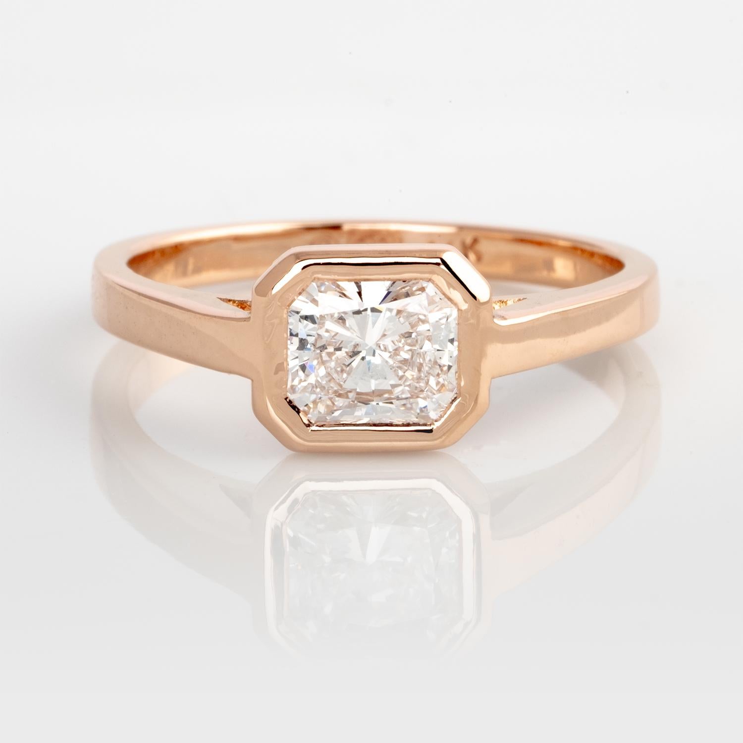 This stunning 14k rose gold ring features a GIA Certified 1.04 carat Radiant cut diamond bezel set East to West. 
The sleek and secure bezel is floating above a 2.5mm wide band.
Currently ring size 9.5 but can be resized at no extra charge.
A