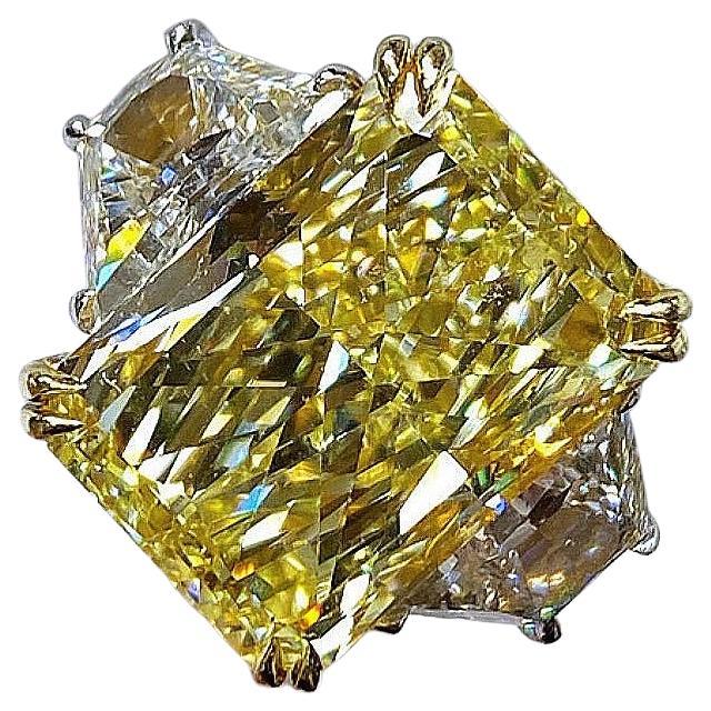This stunning GIA-certified ring features the same remarkable 10.44 carat fancy yellow diamond as the centerpiece, set in a unique two tone 18k gold setting. 

The diamond rests in an 18k yellow gold upper basket, highlighting its warm hue, while