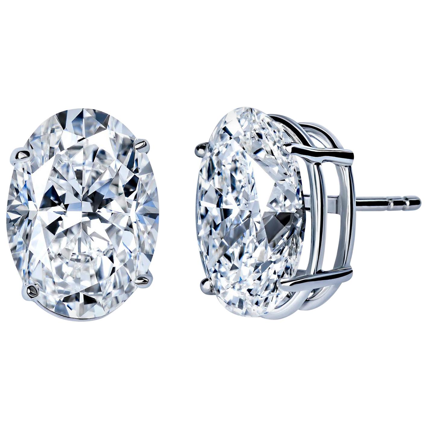 Sophisticated elegance with an edge.
Rare pair of oval shaped diamond stud earrings.
These extraordinary gems weight in at over 5 carats each! for a total combined  carat weight of 10.48 
Oval cut diamonds of this quality are rare, a perfectly