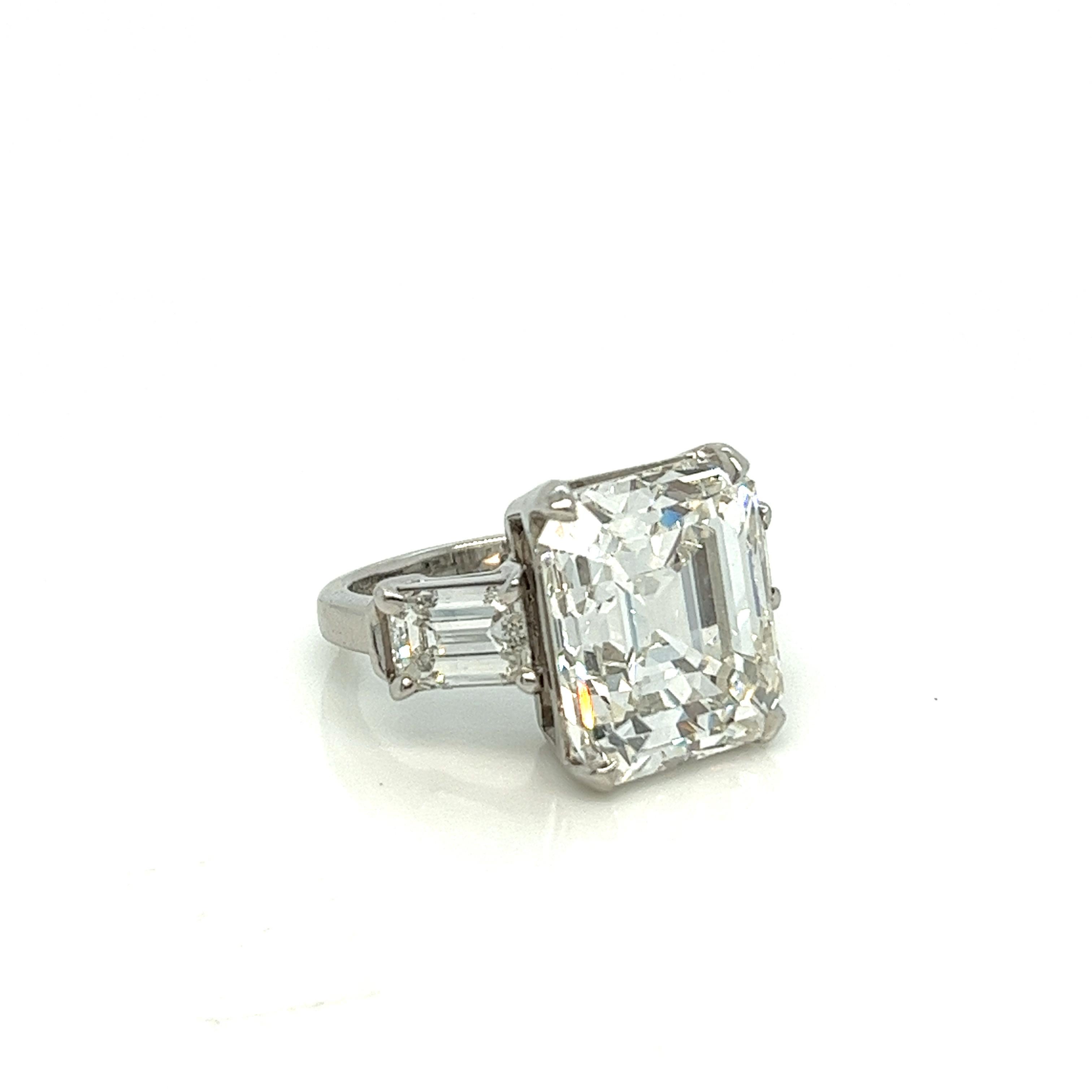 This 10.58 carat antique emerald cut engagement ring is what dreams are made of. The center, a true antique step cut, with her open culet, is stunningly crisp and bright - it's not everyday that you come across a center stone like this. Graded by