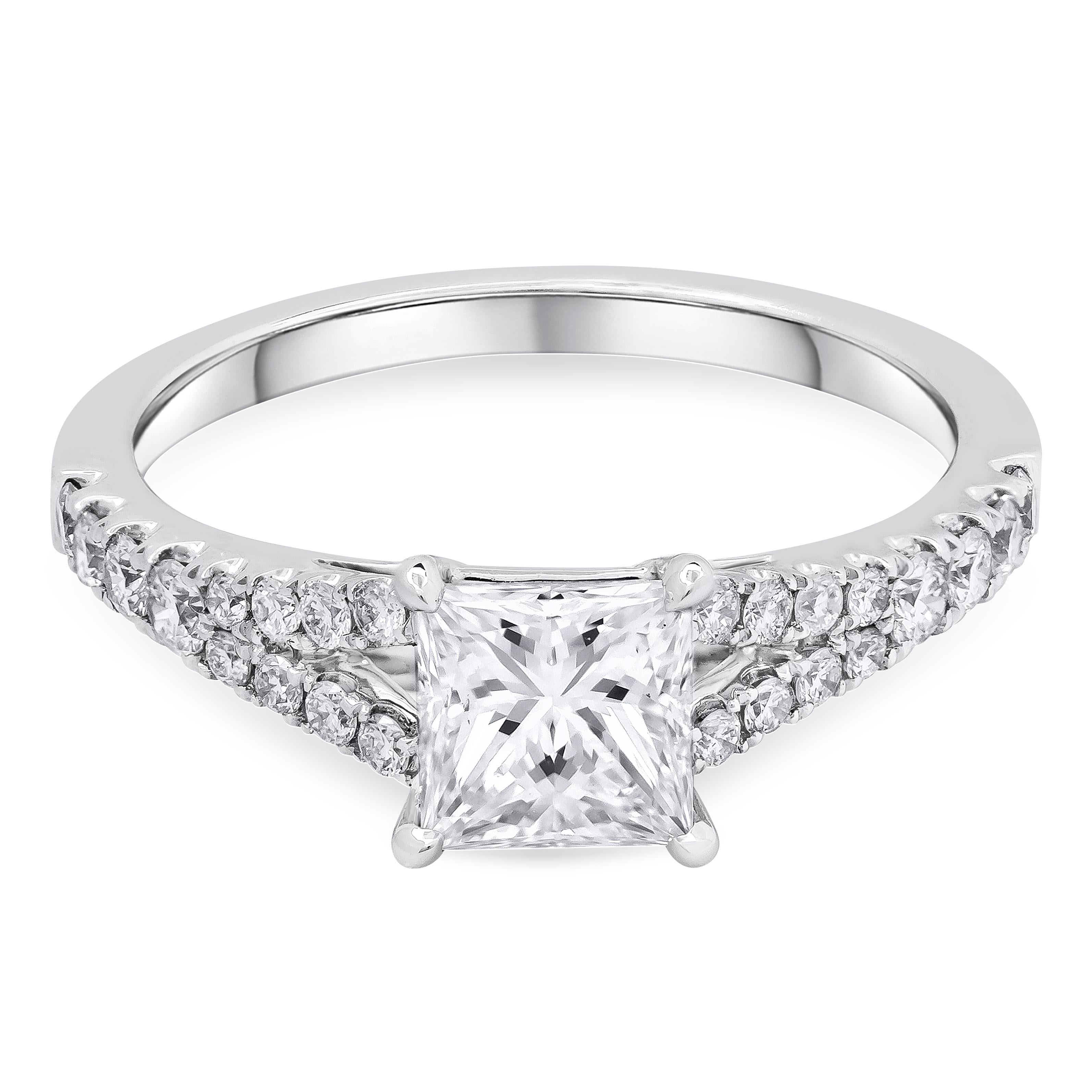 Showcasing a 1.06 carats princess cut diamond center stone takes the spotlight in this 18k white gold setting certified by GIA as G color, VS1 in clarity. Set in a unique and chic split shank setting accented with 0.77 carats total. Finely made in