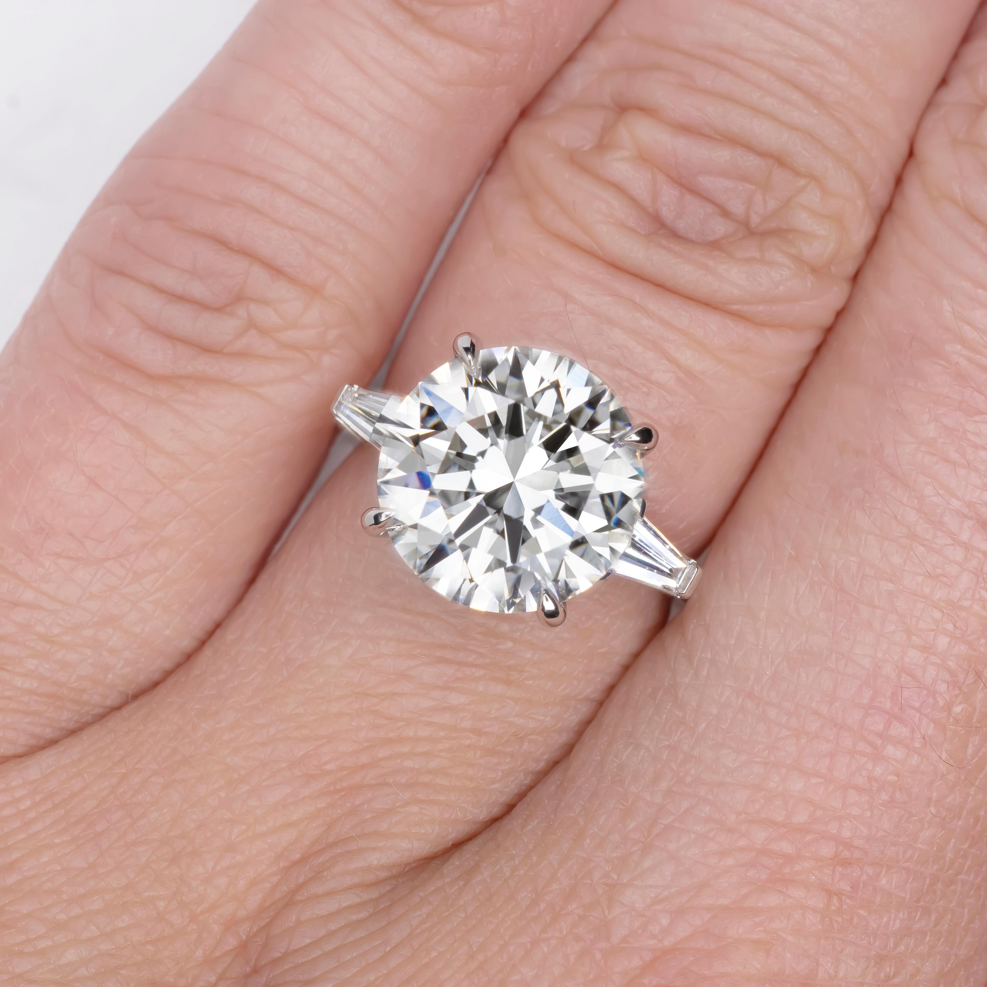 This extraordinary engagement ring features a dazzling 10.66-carat round-cut diamond, GIA certified and celebrated for its unmatched brilliance and presence. 

Graded D for color, the stone reflects the highest standard of purity, showcasing an icy