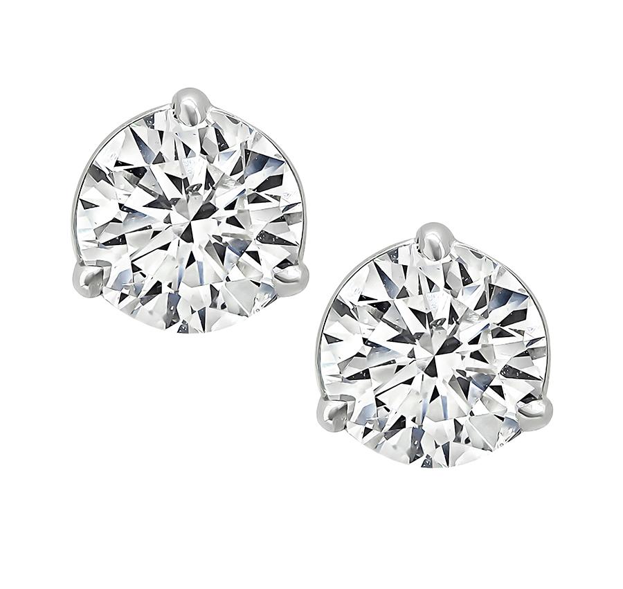 This is a charming pair of diamond 14k white gold stud earrings. The earrings are set with sparkling GIA certified round cut diamonds that weigh 1.06ct and 1.07ct. The color of the diamonds is H with SI2 clarity and G with SI1 clarity. The total