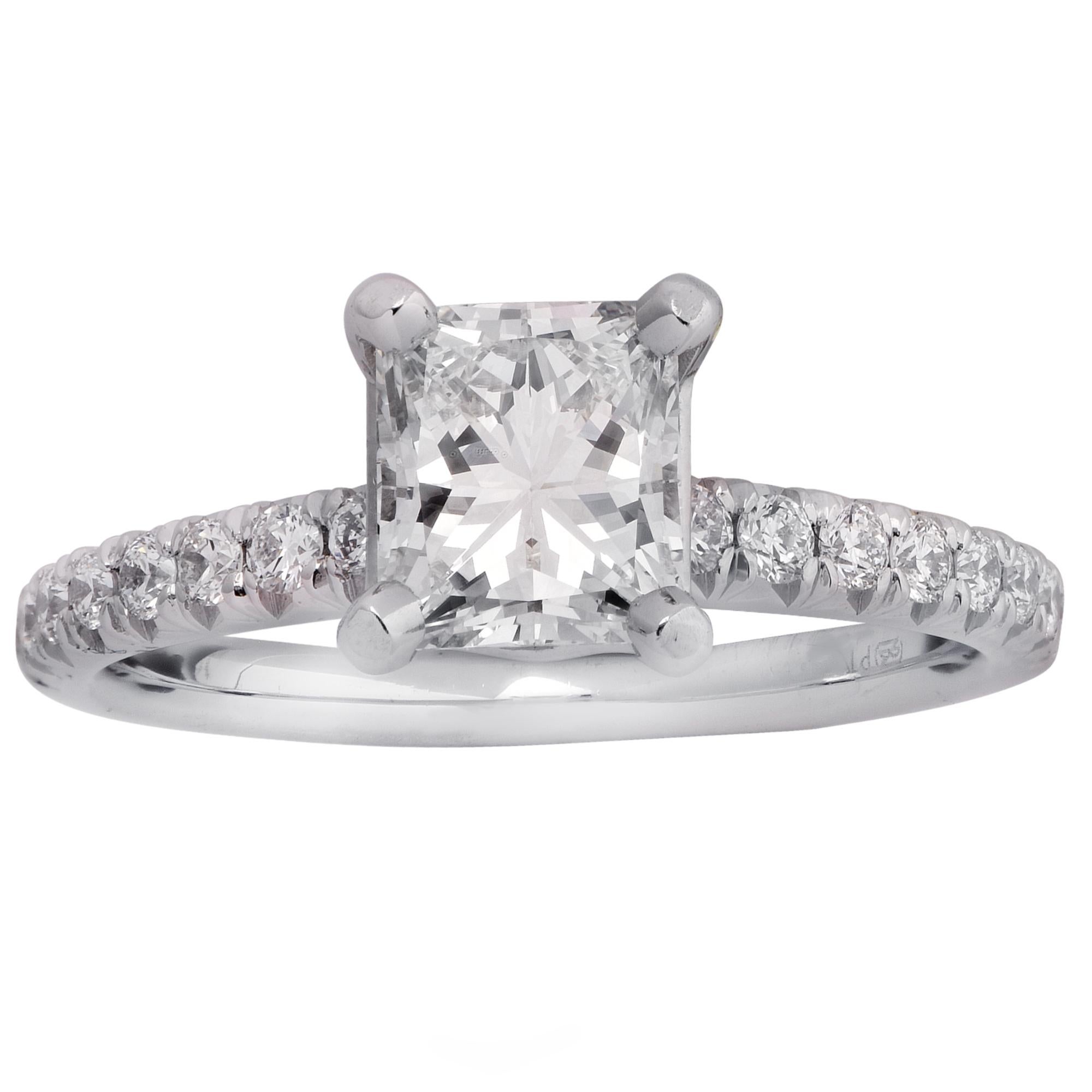 Elegant engagement ring crafted in platinum, featuring a GIA certified 1.07 carat princess cut diamond, J color VVS2 clarity, accented by 16 round brilliant cut diamonds weighing .25 carats total H color VS clarity. This stunning diamond rests on a