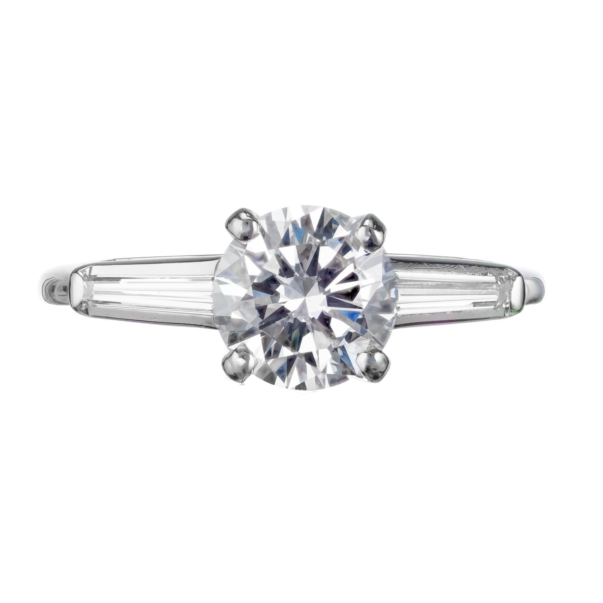 Ideal transitional cut diamond platinum engagement ring. Platinum setting with tapered baguette side diamonds. circa 1960.  GIA certified. 

1 round brilliant cut E VS diamond, Approximate 1.07cts GIA Certificate # 1172689908
2 tapered baguette G VS