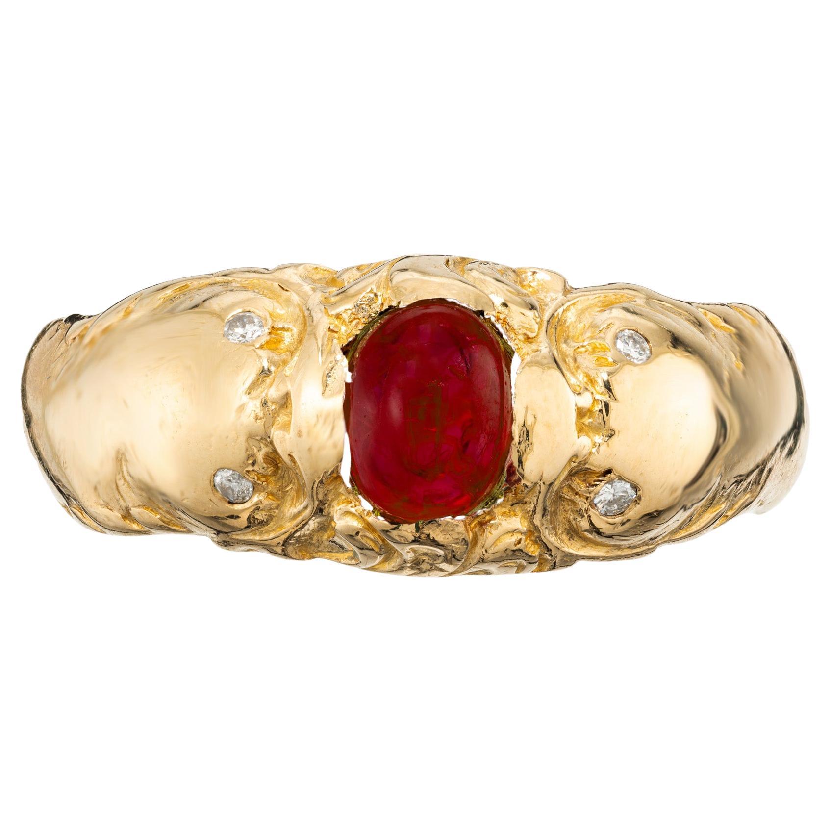 Classic men's fish ruby ring. Set with one oval 1.08ct cabochon ruby and accented with 4 round diamonds. The ruby is mounted in between the mouths of the two fish. The diamonds are set in place of their eyes. The ruby is certified by the GIA as