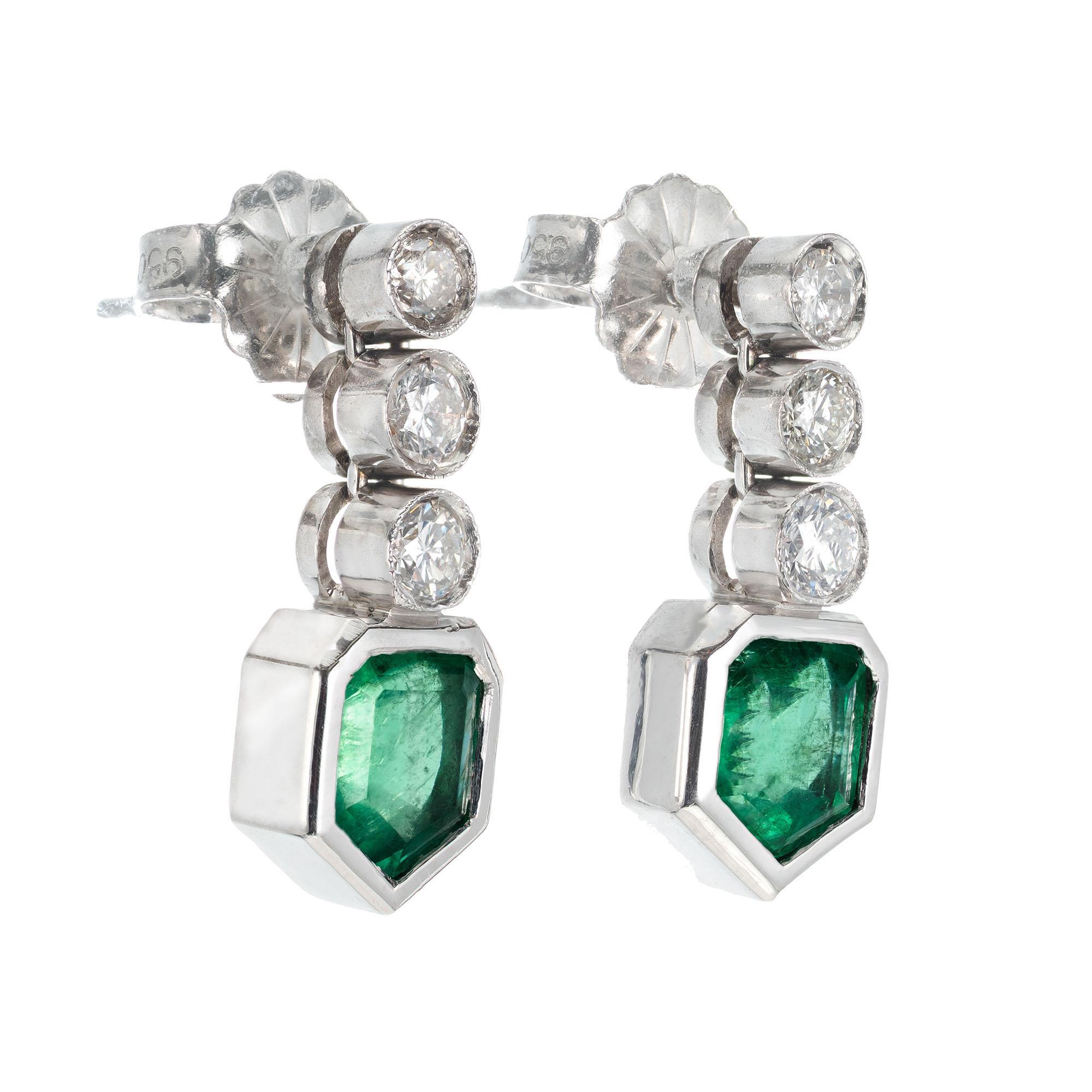 1940's emerald and diamond dangle earrings. Set in platinum with GIA certified random tested shield cut emeralds, natural beryl-emerald with moderate clarity enhancement accented with 6 round brilliant cut diamonds. 

2 shield cut green emeralds F2,