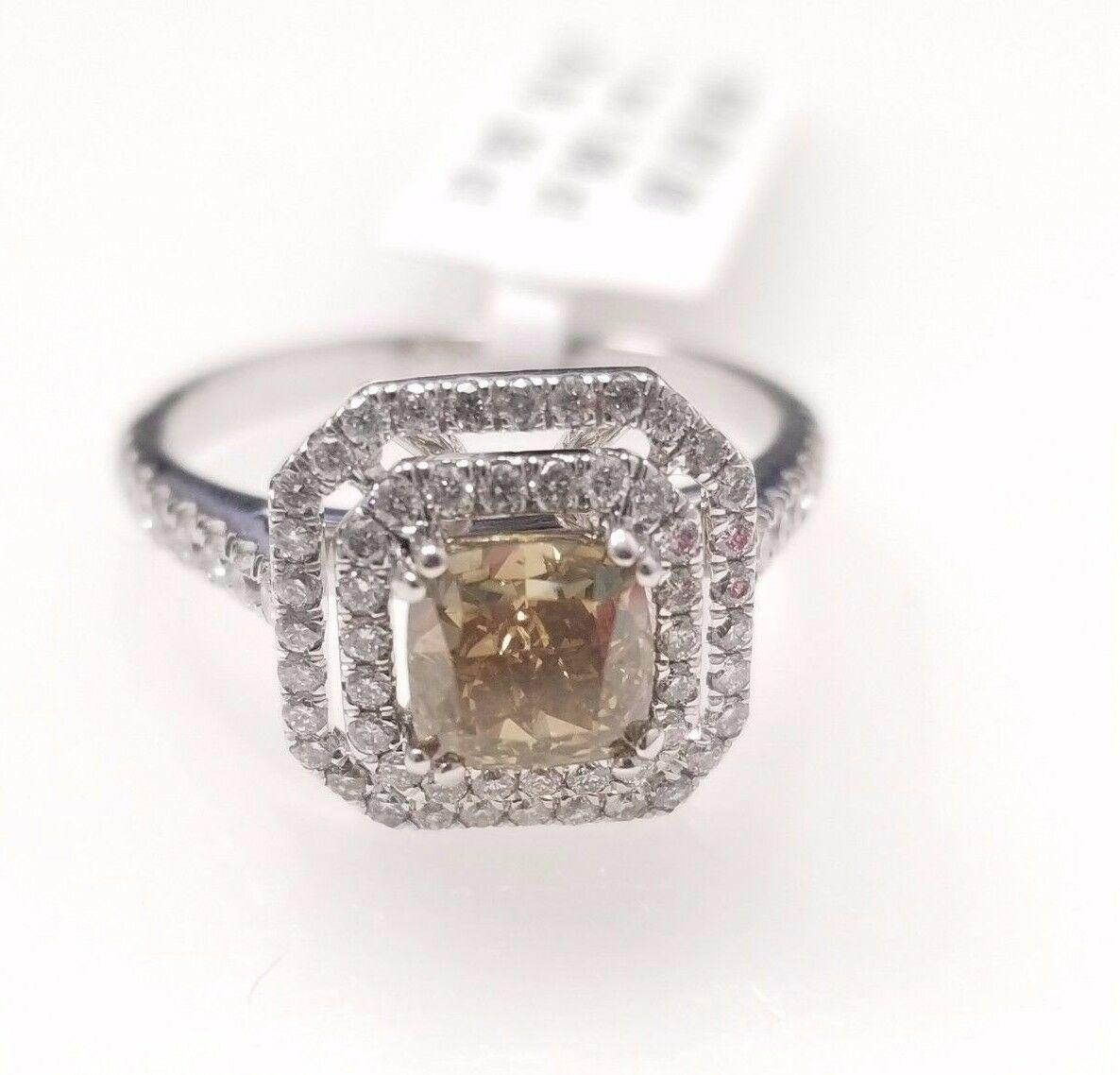 Natural fancy dark brown-greenish yellow cushion cut diamond weighing 1.08 carats. Certified by GIA. beautifully surrounded by round white diamonds and set in 4 prong double halo setting. Its transparency and luster are excellent. 18K white gold,