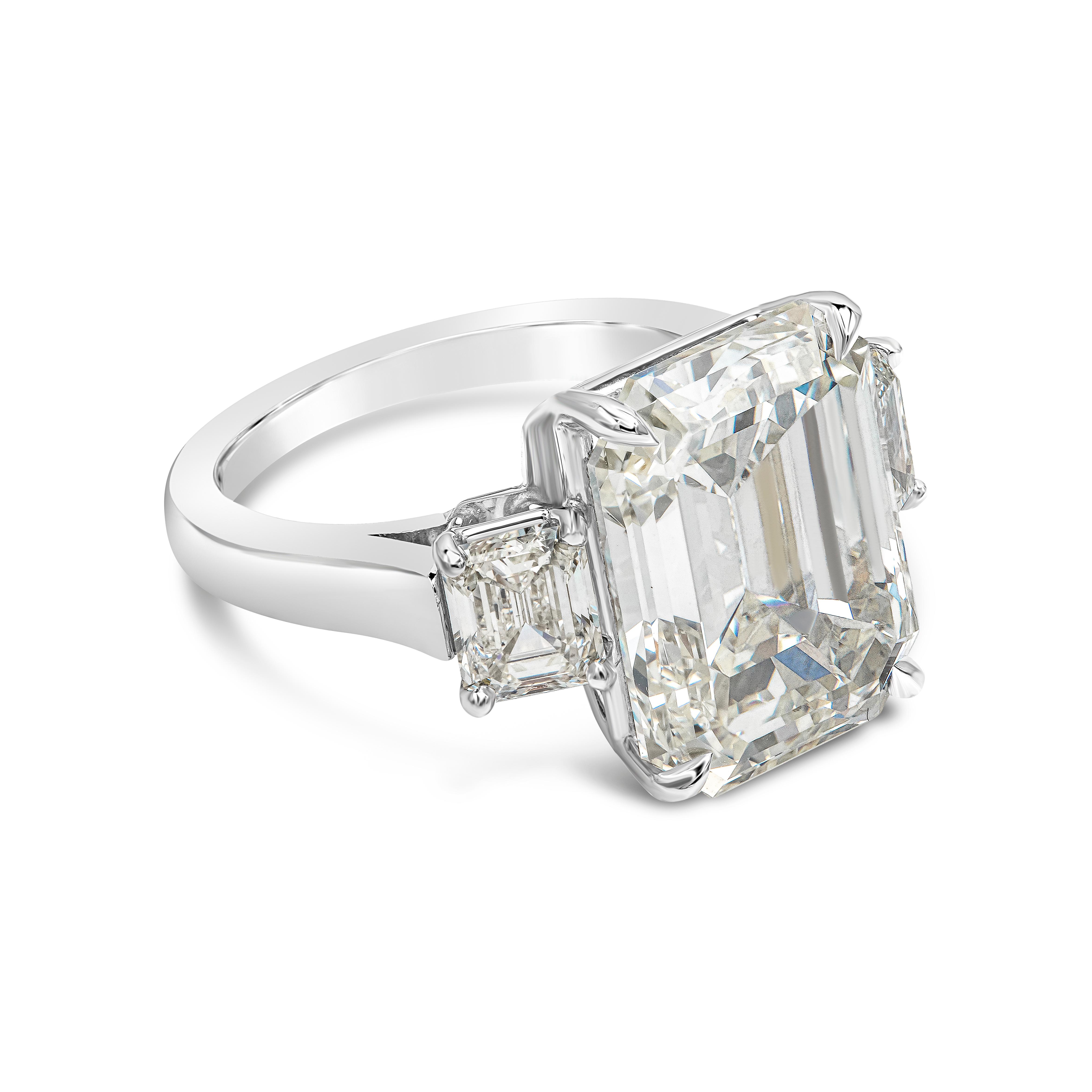 Showcasing a 10.88 carat emerald cut diamond certified by GIA as L color, SI1 clarity, flanked by two small emerald cut diamonds on either side. Accent diamonds weigh 1.45 carats total. Made in platinum. Size 6.75 US (sizable).

Style available in