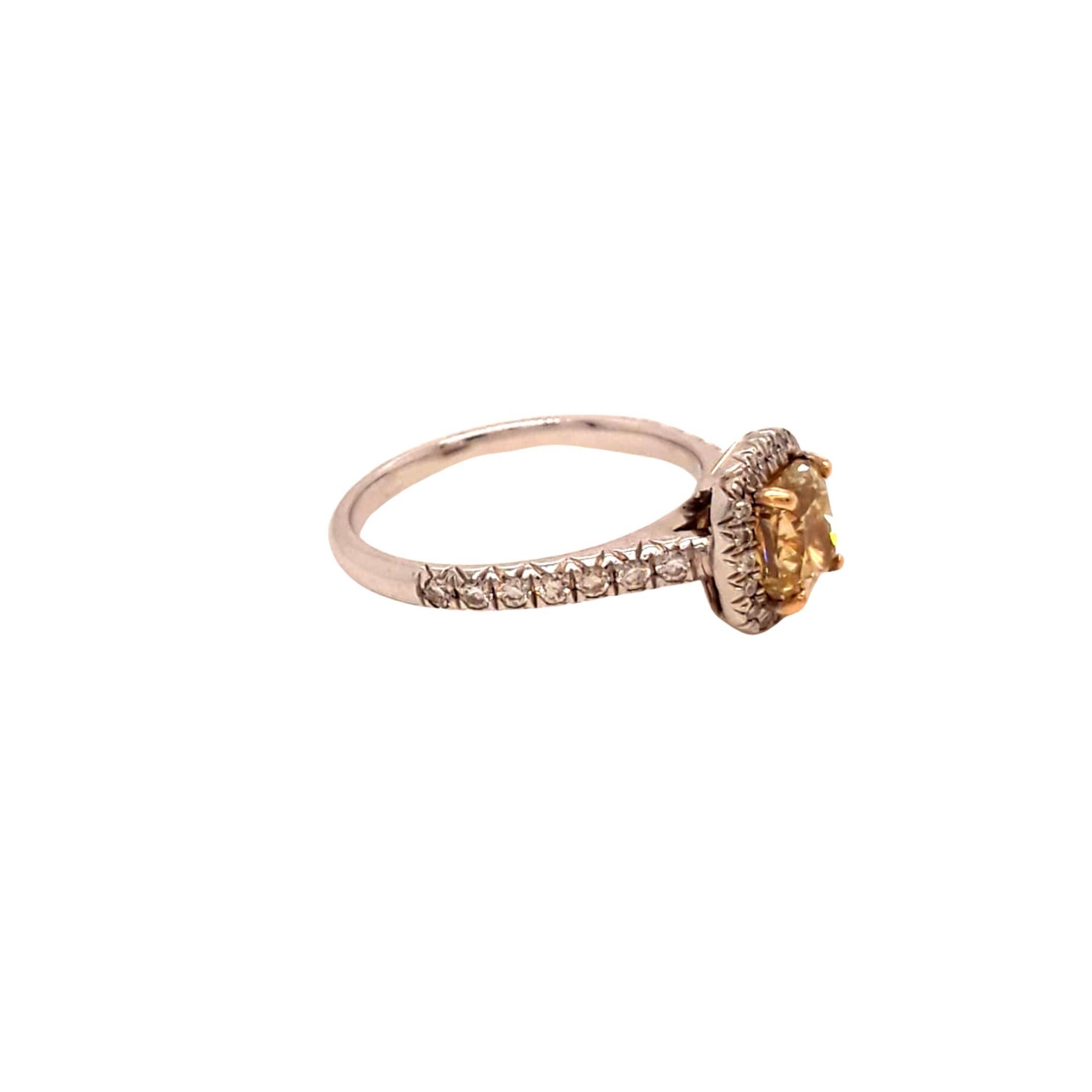 GIA Certified Yellow Cushion Diamond Ring. Total Diamond Weight: 1.36 Carats, Diamond Quantity: 38 diamonds (1 Fancy Yellow Cushion Diamond + 37 Brilliant Cut Diamonds), Diamond Clarity: VS1. Set on 18 karat white gold. Ring size 5.5.