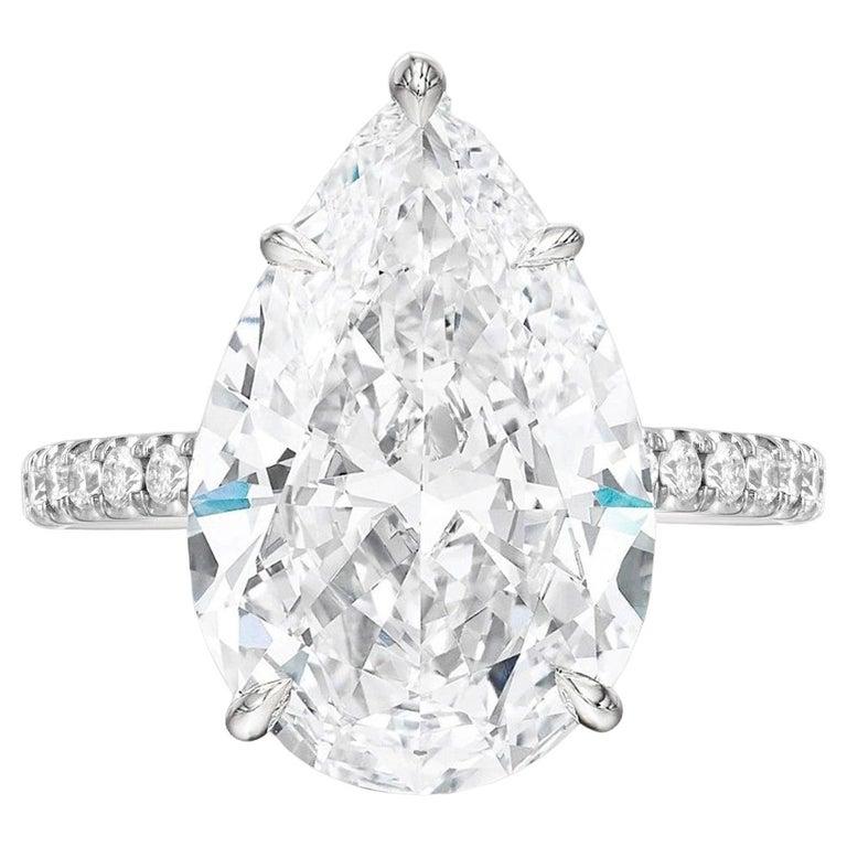 This enchanting engagement ring showcases a GIA certified pear-cut diamond as its centerpiece, radiating with brilliance and grace. Encircling the dazzling pear-shaped diamond is a delicate pavé setting, featuring meticulously placed small diamonds