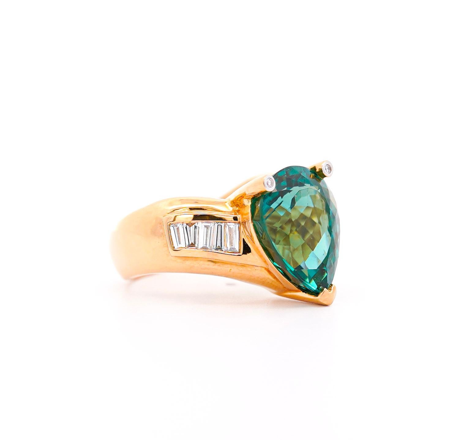 GIA Certified 11 carat bluish green tourmaline and white diamond ring in 18k yellow gold. Featuring a curved v-shaped ring shank that compliments the pear cut center stone. Fixed with baguette-cut natural diamond side stones.

The center stone bears
