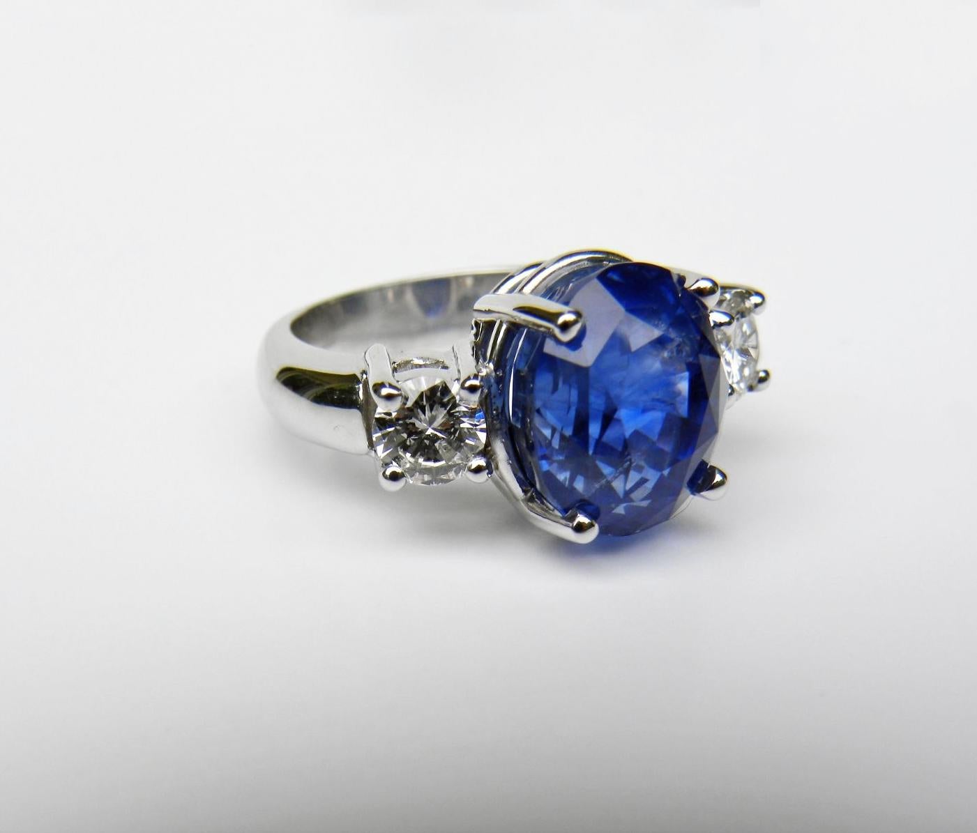 GIA Certified Untreated 11.00 Carat Cornflower Blue Sapphire Diamond Three Stone Engagement Ring 18K
Primary Stones: Natural Untreated Ceylon Sapphire
Total Sapphire Weight :  10.23 Carats HUGE
Sapphire Measurements: 11.81mm x 10.05mm x