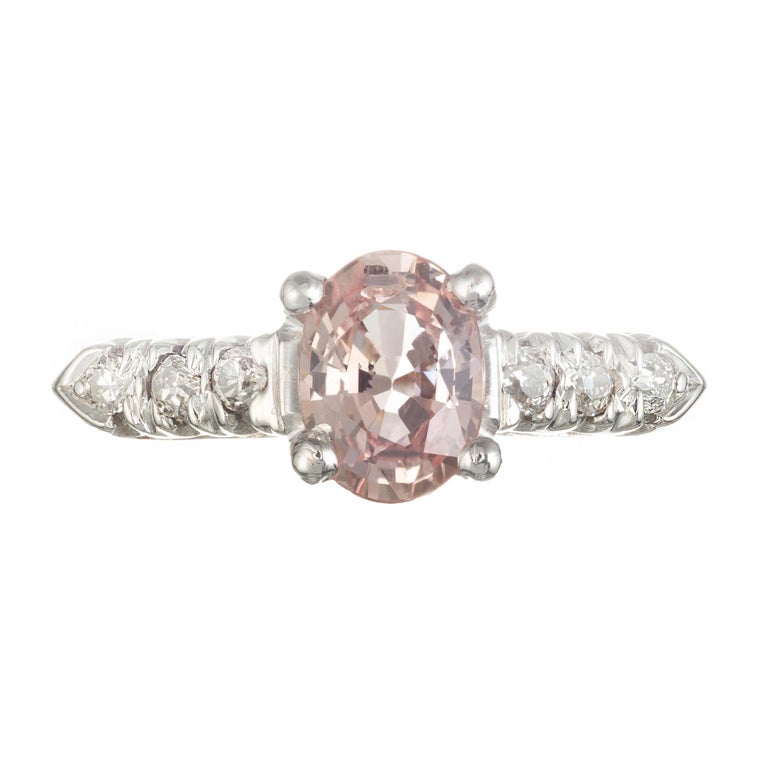 Vintage 1940's Natural 1.12 carat oval bright orange/pink sapphire and diamond engagement ring. Set in platinum 

1 oval brilliant light orange MI sapphire, Approximate 1.12 carats. Gia Certificate # 1176619027
6 round J-K SI diamonds, Approximate
