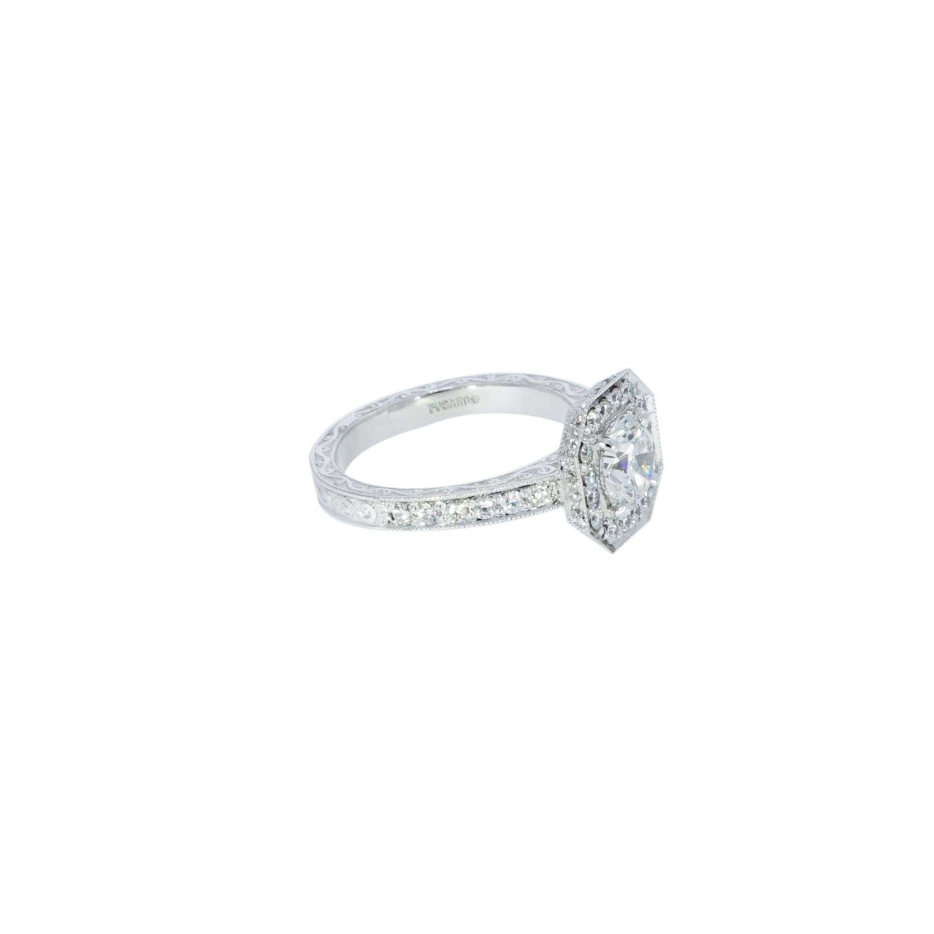 This Halo engagement ring features a GIA certified 1.12 carat center, F color, SI1 clarity,  surrounded by approximately 0.60 carats of shimmering diamonds in our vintage style beaded halo atop and a hand engraved Platinum shank with diamonds on the
