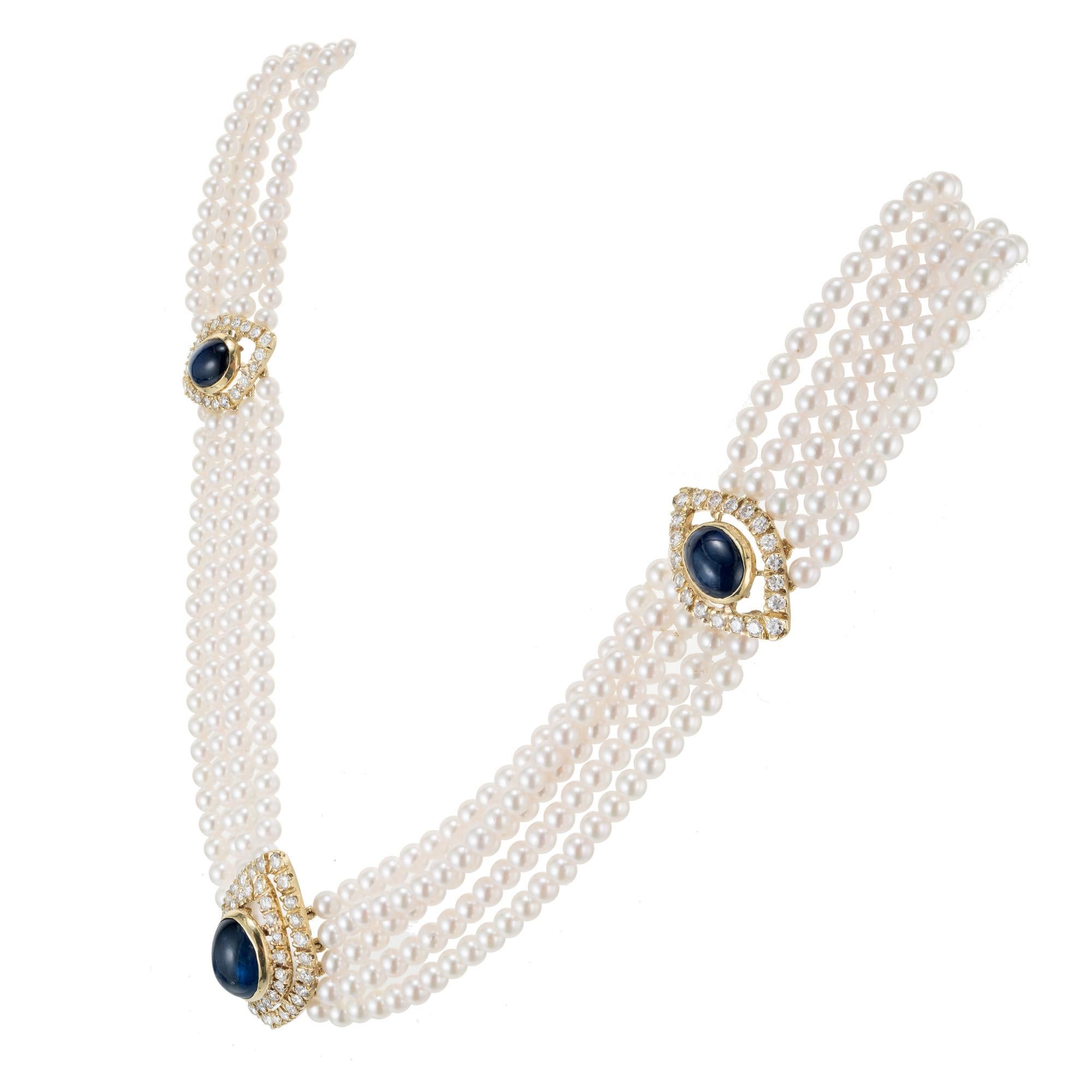 Uniquely crafted five strand Japanese cultured pearl and sapphire 18k yellow gold necklace. 4 oval cabochon sapphires, each with a halo of round cut diamonds, connected with 5 strands of cultured pearls. 17 inches long. GIA certified.  

1 cabochon