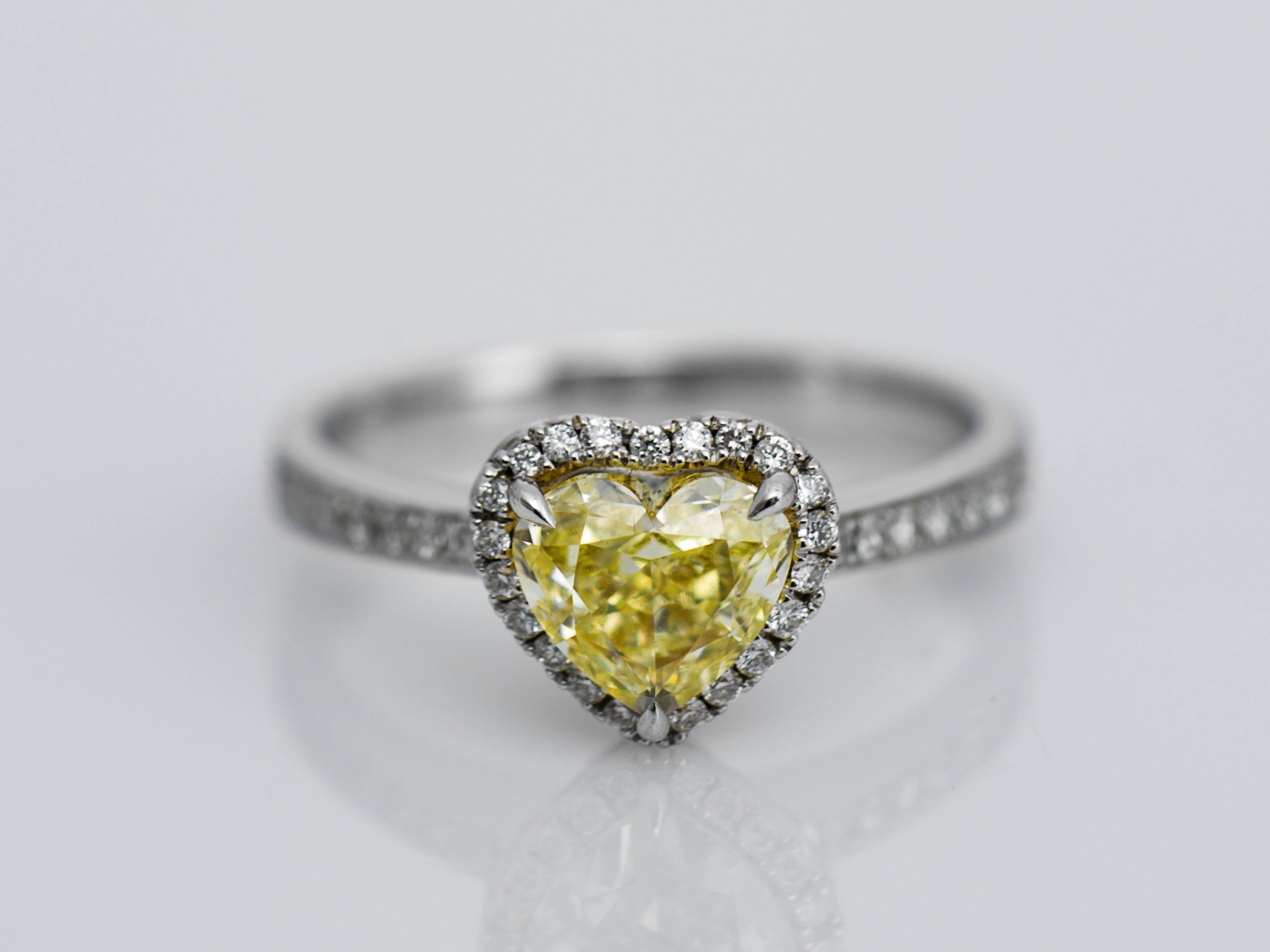 The delicately handmade MIIORI ring features a fancy yellow brilliant cut heart shaped diamond weighing 1.13 carats in the centre of the ring, bordered by 67 small pavé-set diamonds, mounted in solid 18k white gold. This ring is absolutely elegant