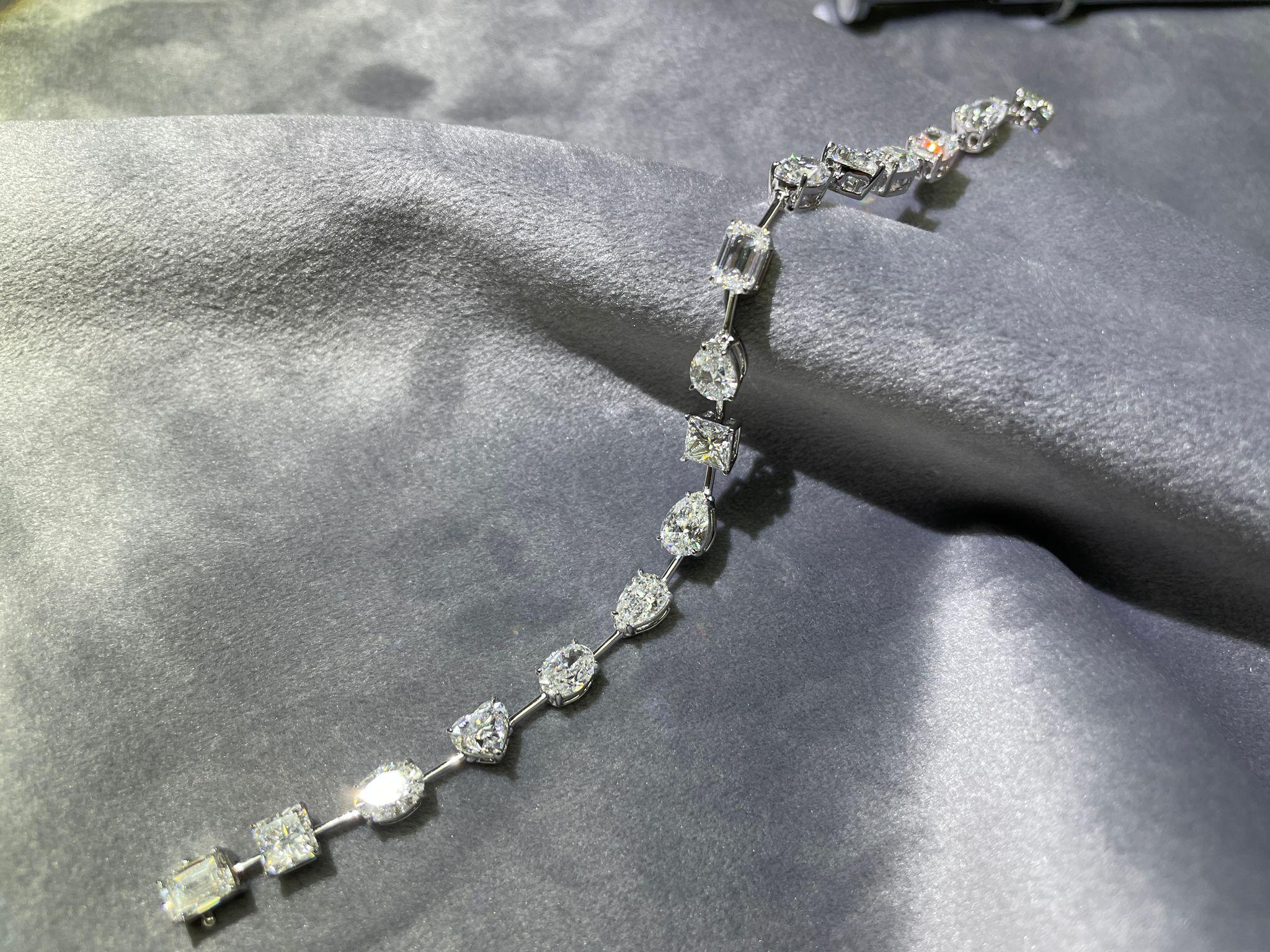 0.7 carat each, mixed shape White Diamond bracelet, with all D/E/F color, VS/SI quality, GIA certified stones. The bracelet consists of 16 pieces, all set in solid 18K White Gold
Please feel free to message us for more information. 
We provide free