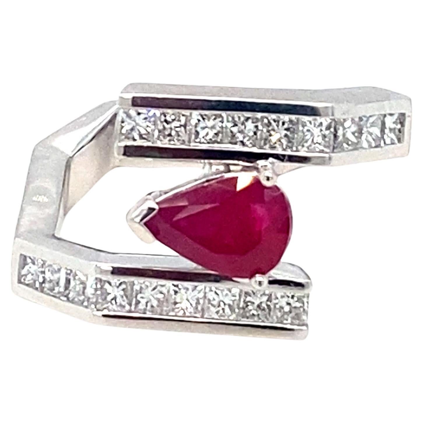 This exquisite ring showcases a GIA-certified 1.13 carat Burmese pear-cut ruby and 0.87 carats of sparkling diamonds with VS1-VS2 clarity. Set in a beautifully crafted platinum band, the contemporary design highlights the vibrant rubies and