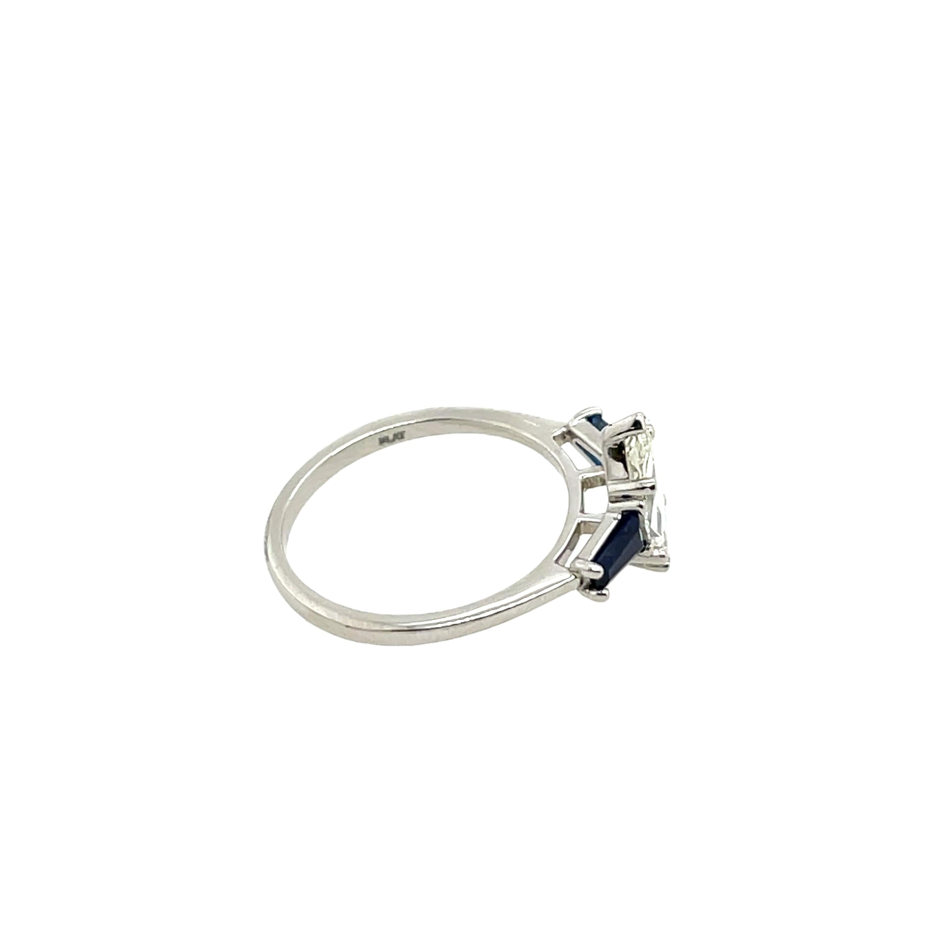 This stunning ring features a GIA-certified 1.13ct marquise-cut diamond, flanked by two beautifully matched sapphires. 
Set in a sleek band, the sparkling diamond is perfectly complemented by the rich blue hues of the sapphires, creating an elegant