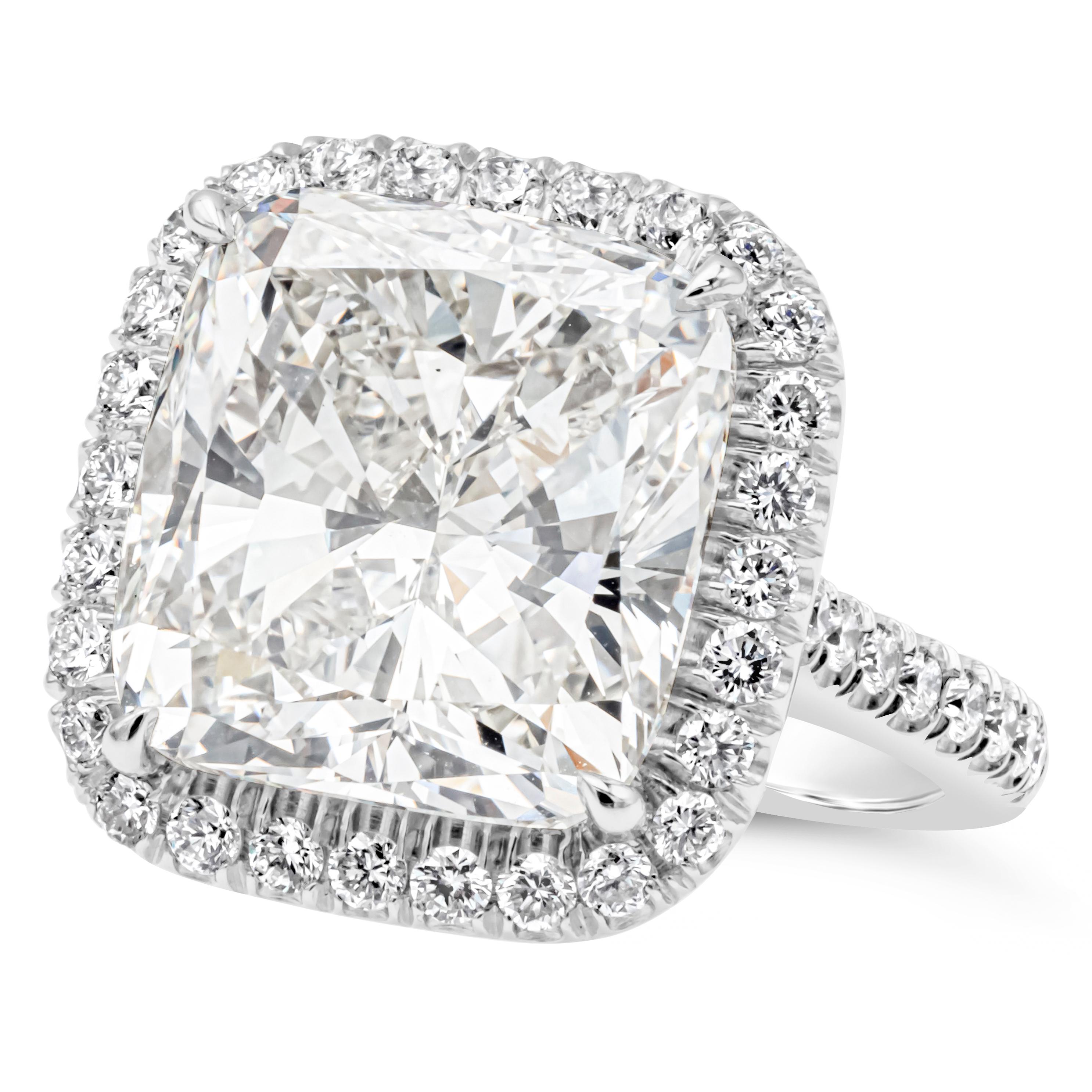 Brilliant and elegantly made halo engagement ring showcasing a GIA certified 11.46 carats cushion cut diamond, J Color and VS2 in Clarity. Set in a platinum four prong setting and surrounded by a row of brilliant round diamonds. Platinum shank is