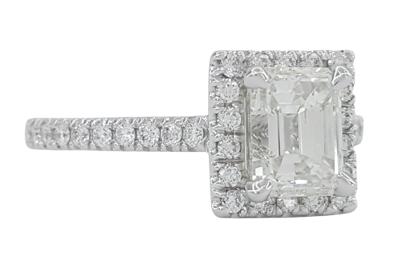 This elegant engagement ring features a 1.17 carat emerald cut diamond at its center, offering a sophisticated and timeless appeal. The diamond is GIA certified, ensuring its authenticity and quality. With a color grade of J, it has a warm and