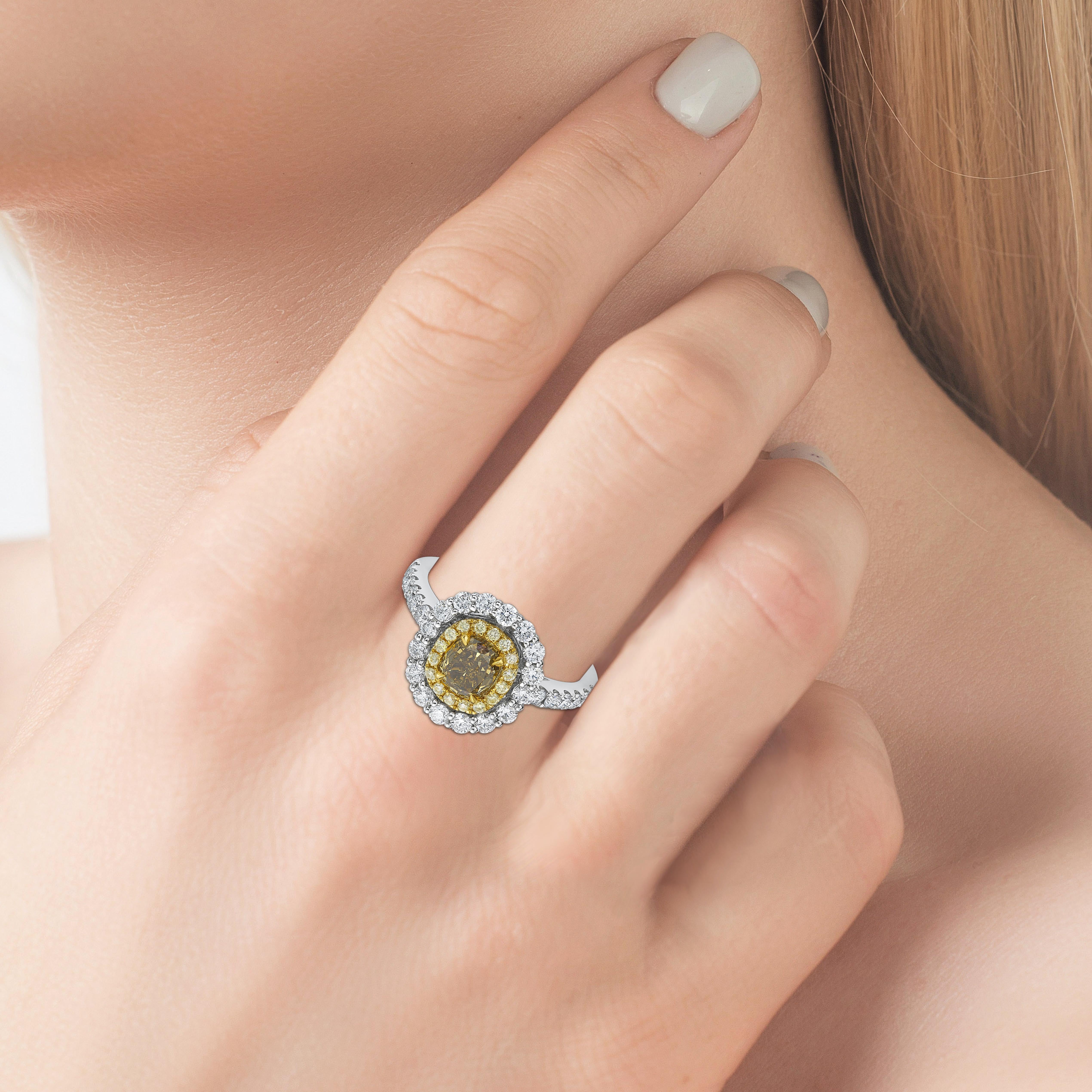 Everyday Classic designed ring featuring a  1.15 carat Modified cushion cut Fancy Deep Brownish Greenish Yellow Diamond with white and yellow diamond halo finished in white gold. 

Center stone certified by world wide known GIA institution.
