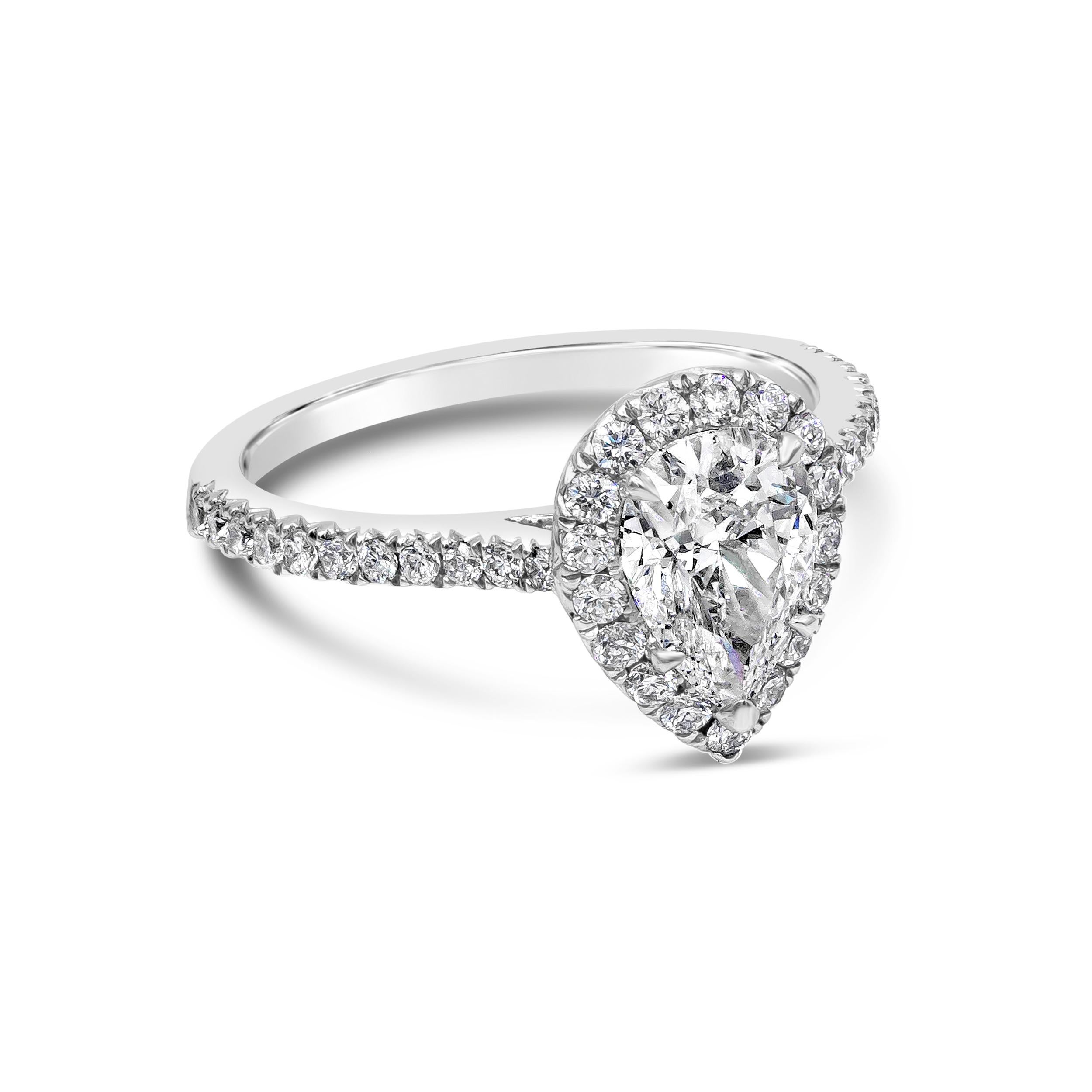 An elegant engagement ring showcasing a 1.16 carats pear shape diamond center stone certified by GIA as D color and SI1 in clarity. Surrounded by a single row of 39 brilliant round diamonds in halo pave setting weighing 0.49 carats total. Diamond