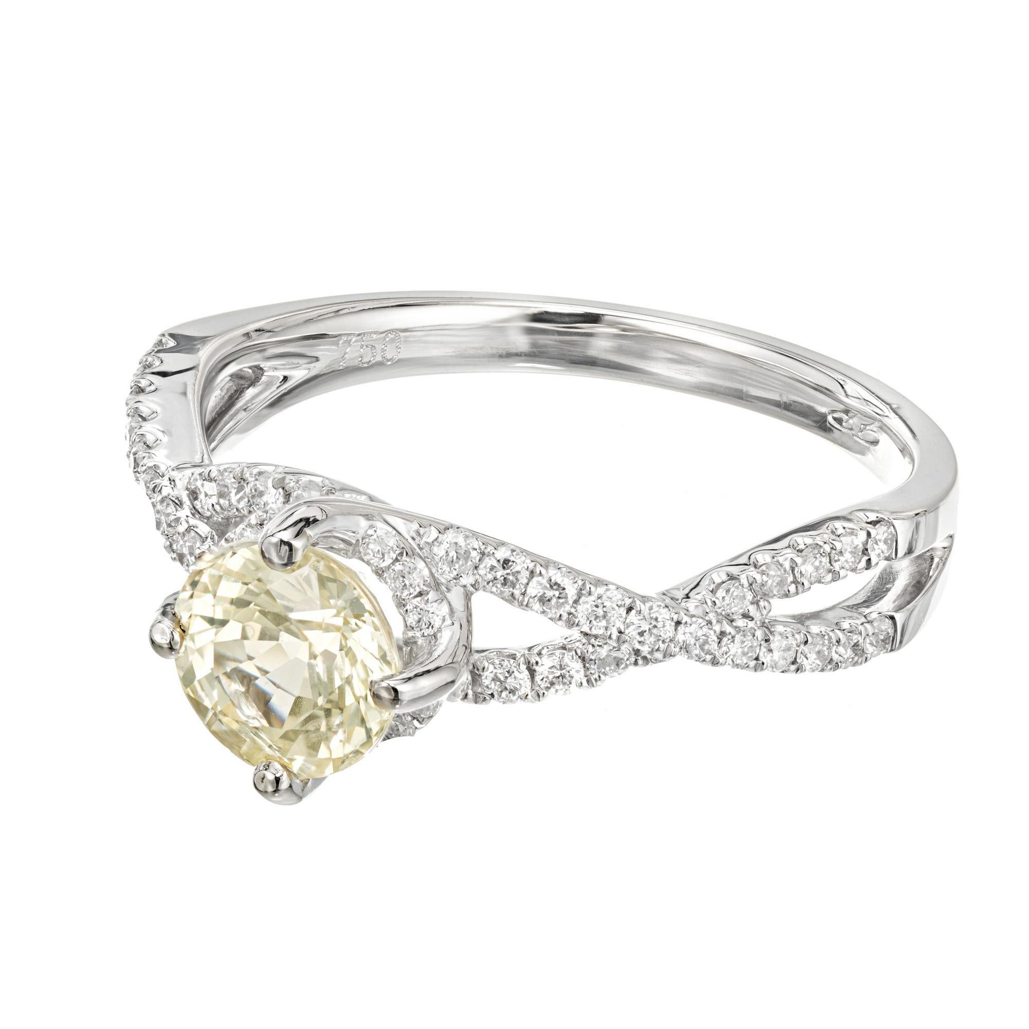 Natural light yellow sapphire and diamond engagement ring. GIA certified natural no heat light yellow center Sapphire, set in an 18k white gold swirl setting with 54 round accent diamonds. 

1 round light yellow Sapphire, approx. total weight