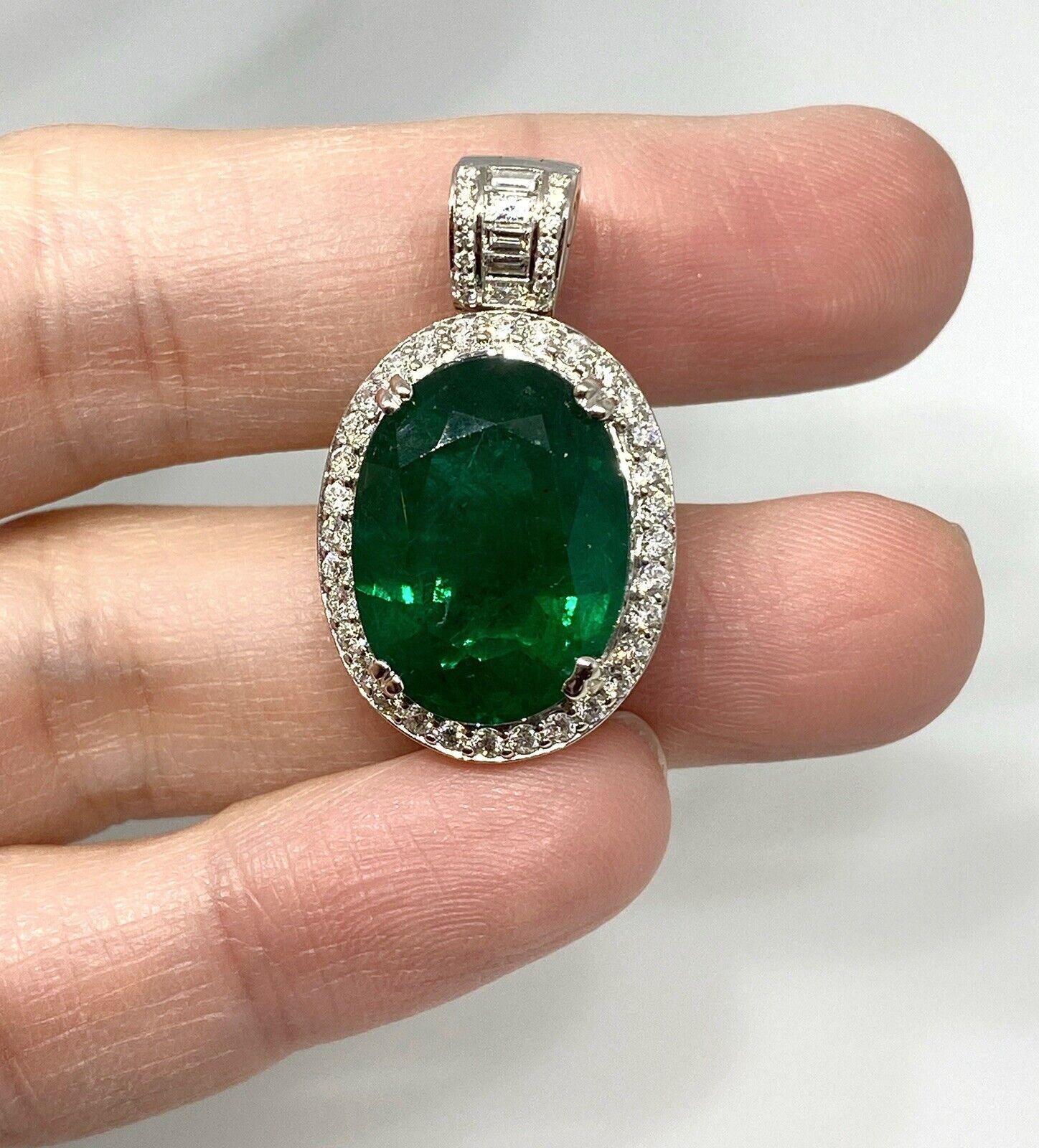 GIA certified 11.76 Carat Oval shaped Emerald and Diamond Pendant

Oval Emerald and Diamond Pendant features One Oval Emerald surrounded by Round Brilliant cut Diamonds with Round and Baguette Diamonds on the bail set in 18k White Gold. The emerald