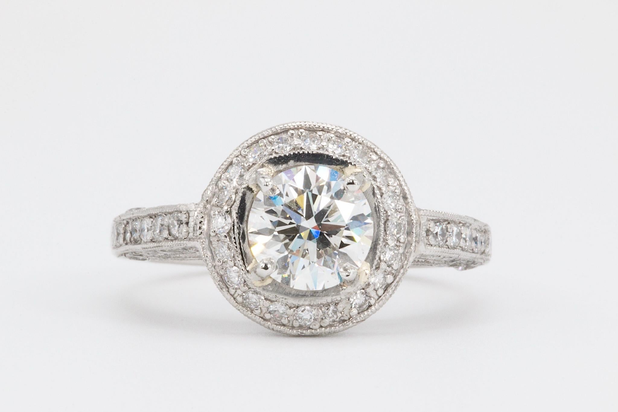Crafted in platinum, this classic engagement ring features an estimated total diamond weight of 2.25 carats. At its center is a stunning 1.18-carat round brilliant-cut diamond graded G in color and VS2 in clarity by GIA (original report # 5253316875