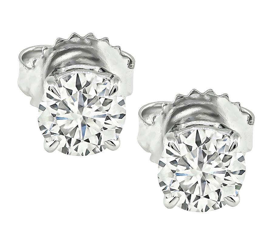 This is a gorgeous pair of diamond 14k white gold stud earrings. The earrings are set with sparkling GIA certified round cut diamonds that weigh 0.60ct and 0.58ct. The color of the diamonds is E with I1 clarity and F with I1 clarity. The total