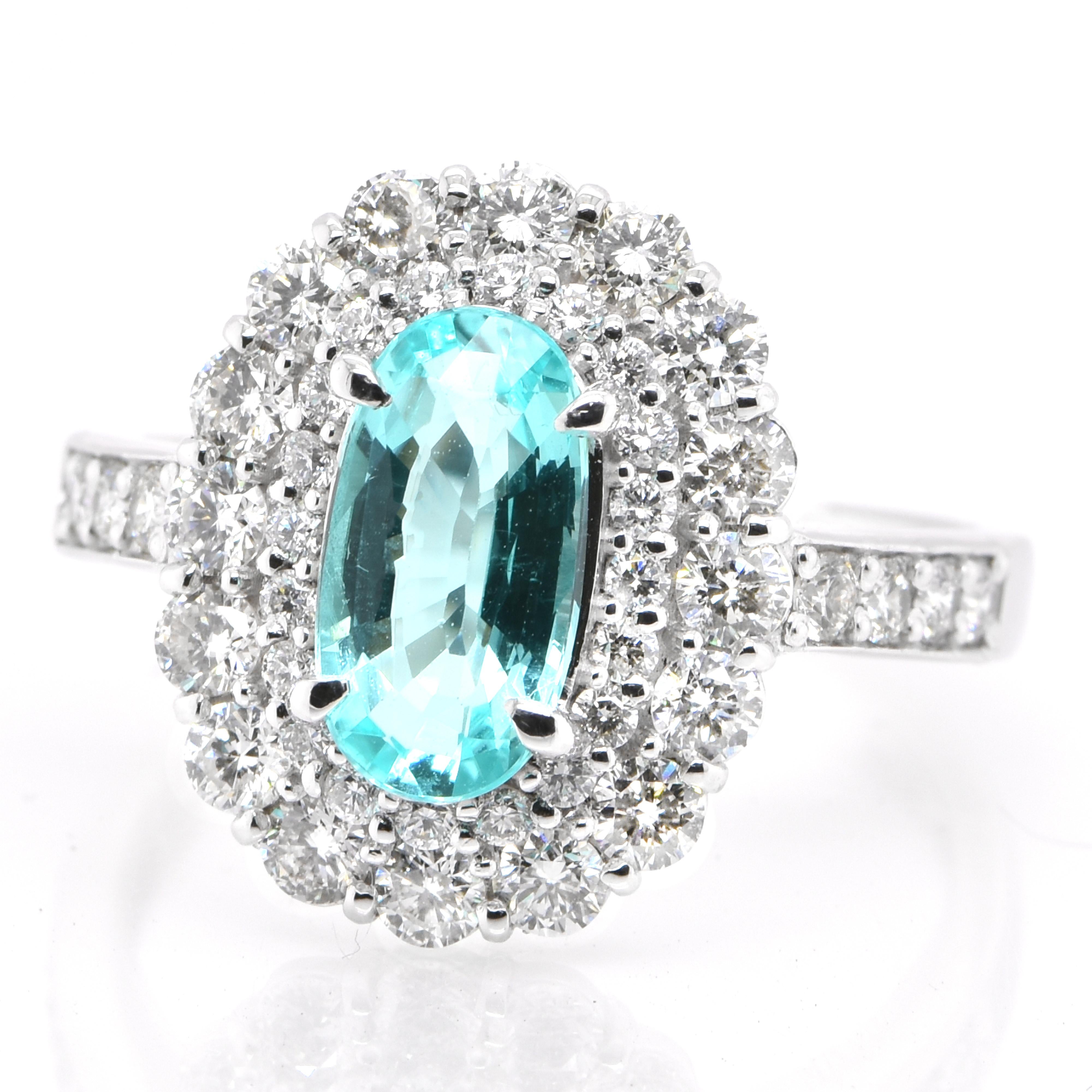 A beautiful ring featuring a GIA Certified 1.19 Carat Natural Mozambican (South East Africa) Paraiba Tourmaline and 1.05 Carats of Diamond Accents set in Platinum. Paraiba Tourmalines were only discovered 30 years ago in the Brazilian state of the