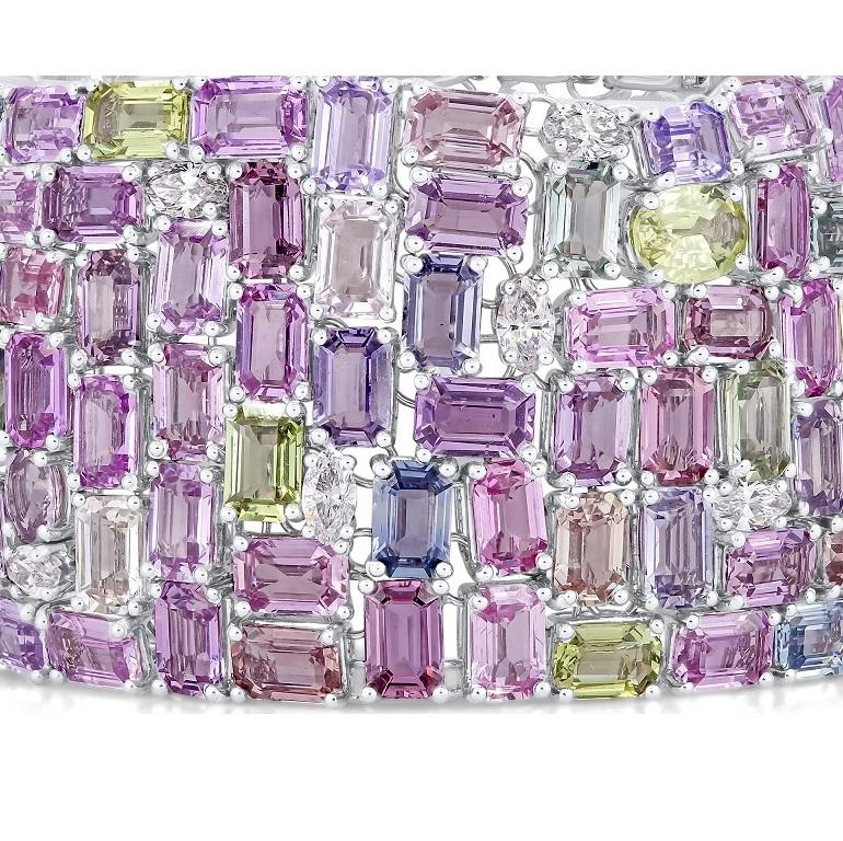 This extravagant, gorgeous bracelet features 119.06 carats emerald cut and oval cut sapphires, including pink, yellow, green, lavender, and light blue. 3.68 carats marquise and round cut natural diamonds are tucked inside the densely packed