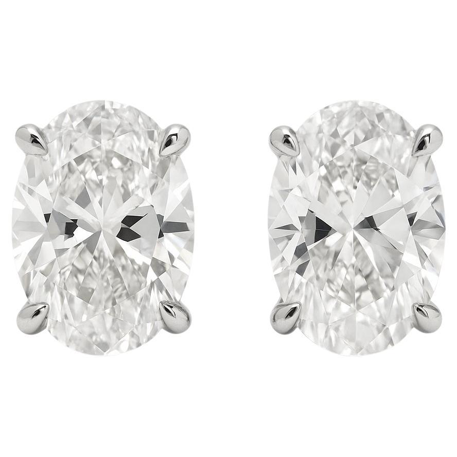 GIA Certified 12 Carat Oval Diamond Platinum Stud Earrings For Sale