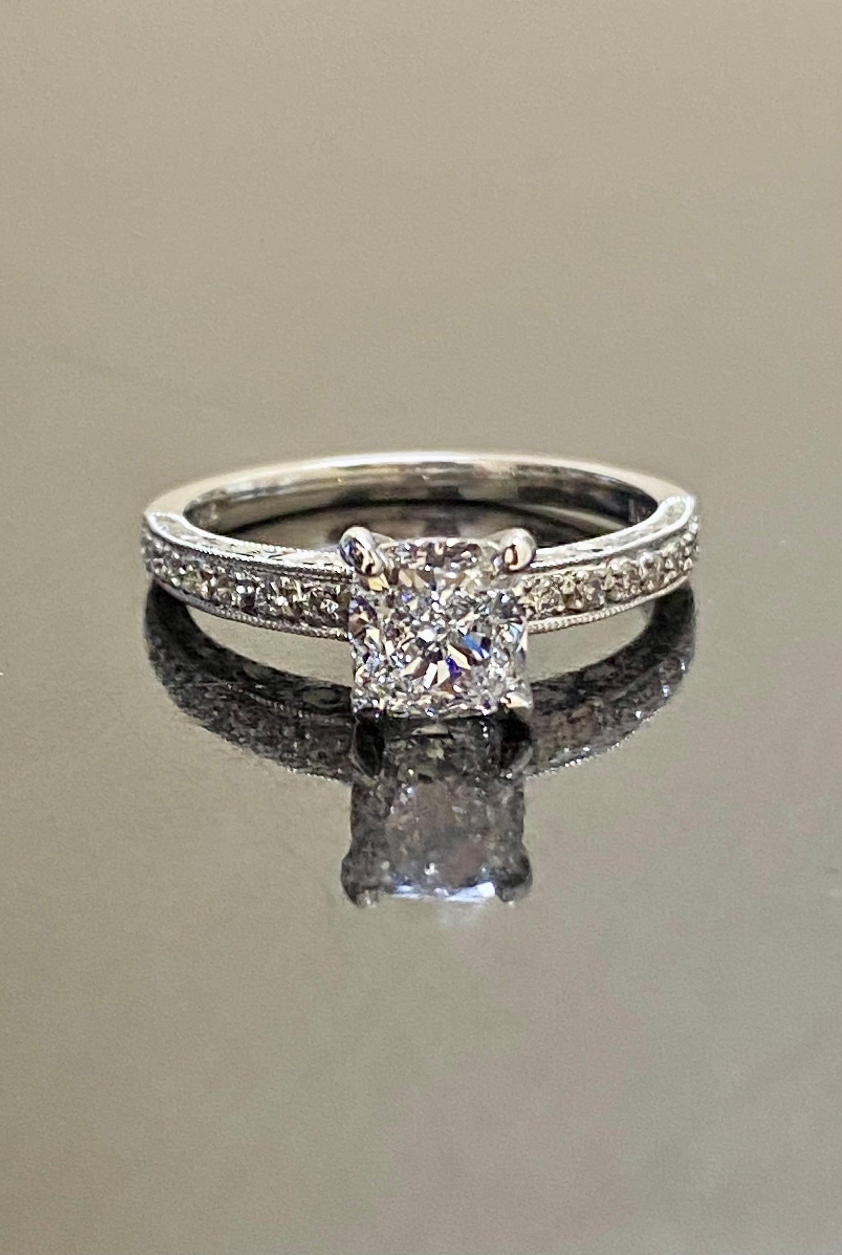 DeKara Design Collection

Handmade Art Deco Hand Engraved Platinum Cushion Cut Diamond Engagement Ring.

Metal- 90% Platinum, 10% Iridium.

Stones- GIA Certified Cushion Cut Diamond Center D Color SI1 Clarity 1.20 Carats, 14 Round Diamonds, G color
